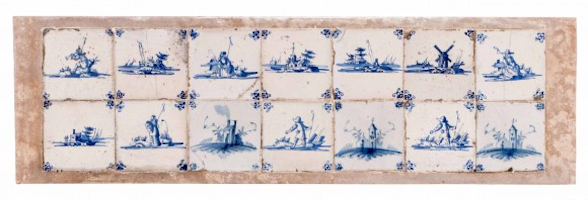 14 blue and white, early 18th century Dutch, delftware tiles, with characteristic landscape scenes mounted in a reconstituted stone plaque.
                