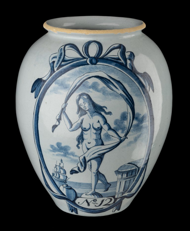 Blue and white tobacco jar ‘No. 12’ Delft, 1750-1800 
The Lampet Jug pottery Mark: LPKan 

The ovoid tobacco jar has a protruding rim and is painted in blue with a large oval depicting Fortuna. To her left is a tobacco jar, to her right a closed
