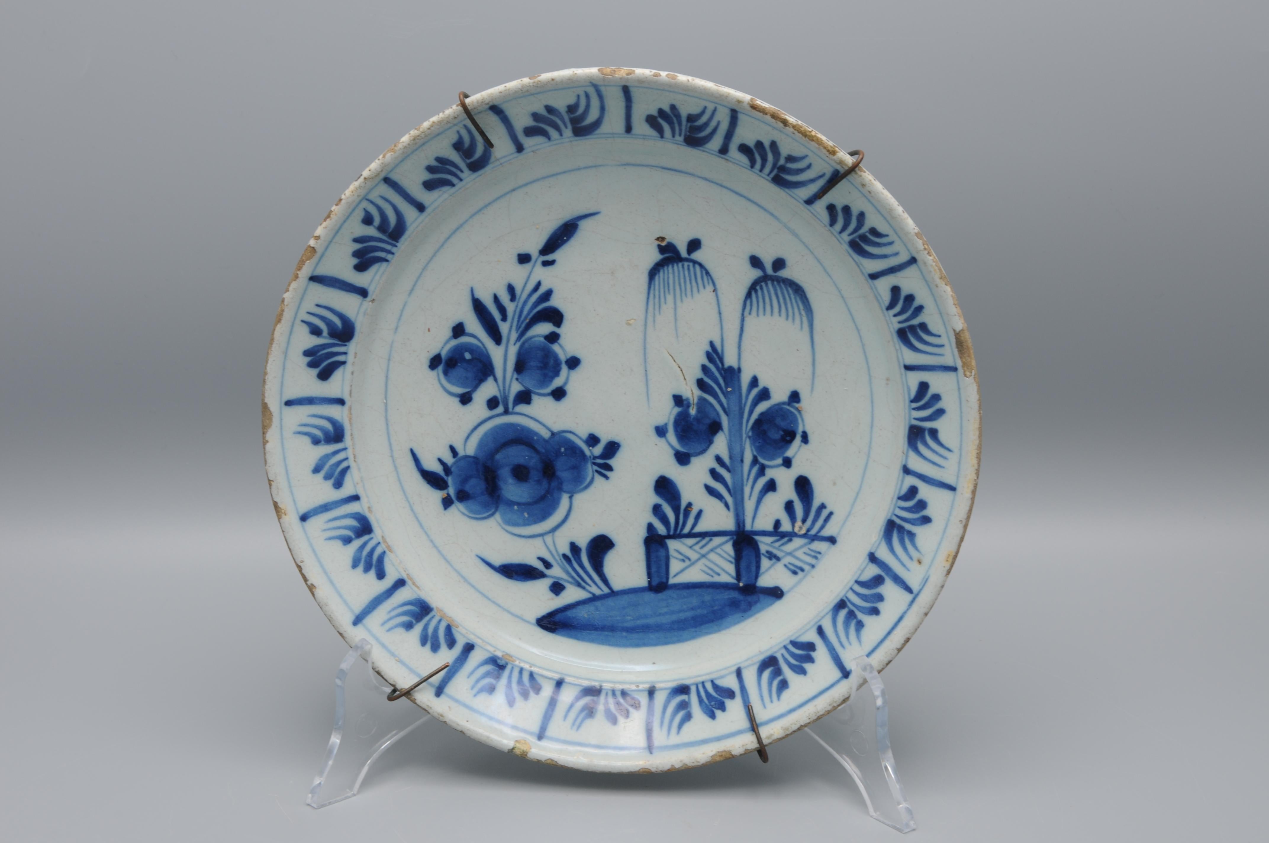 Assiette en faïence de Delft à décor en chinoiserie bleue d'un saule derrière une clôture. Fin du 18e siècle. 

Très bon état : usure habituelle et écaillage du bord.