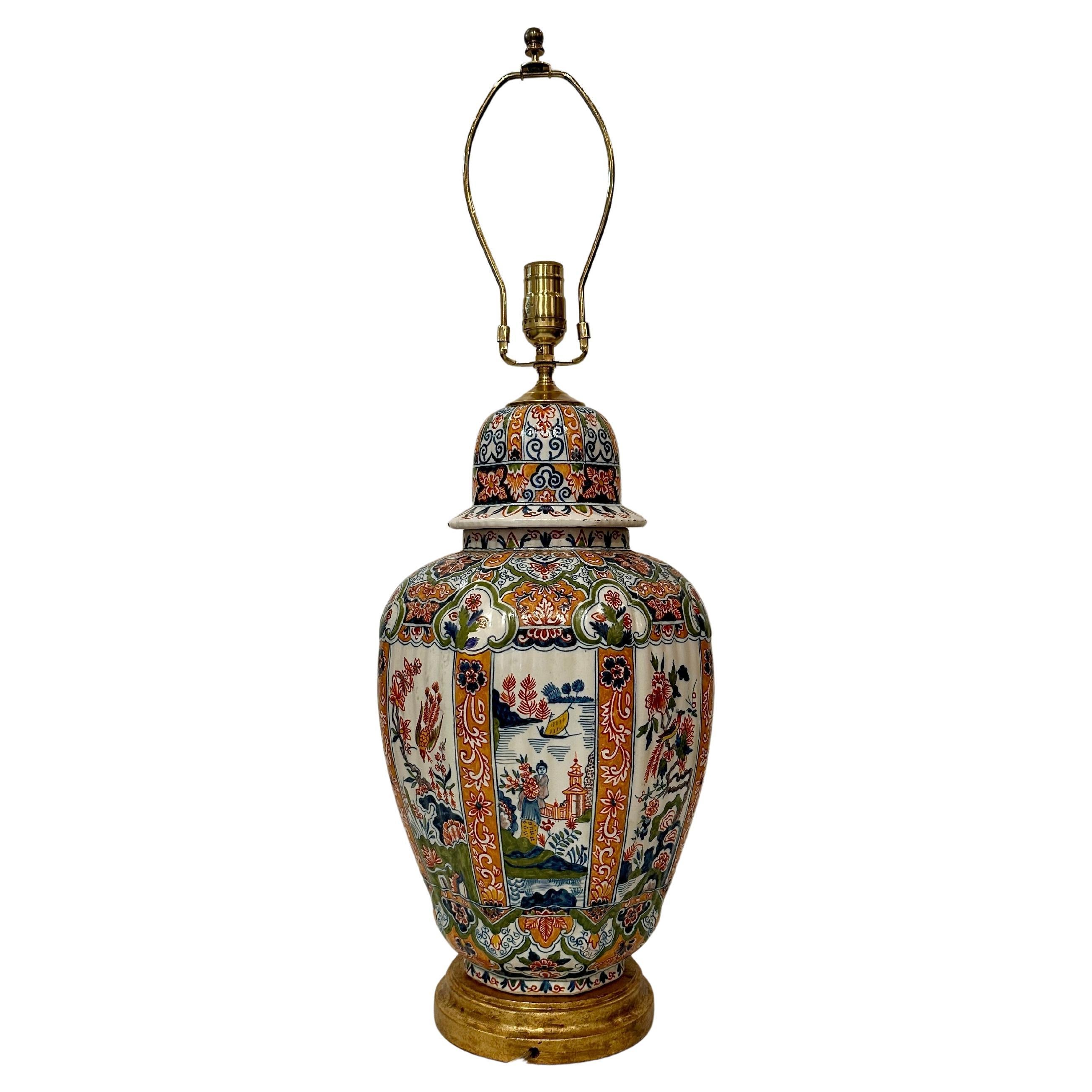 19th century, Delft covered jar, later as a lamp with gilt-wood base.  Single bulb, knob switch.  18