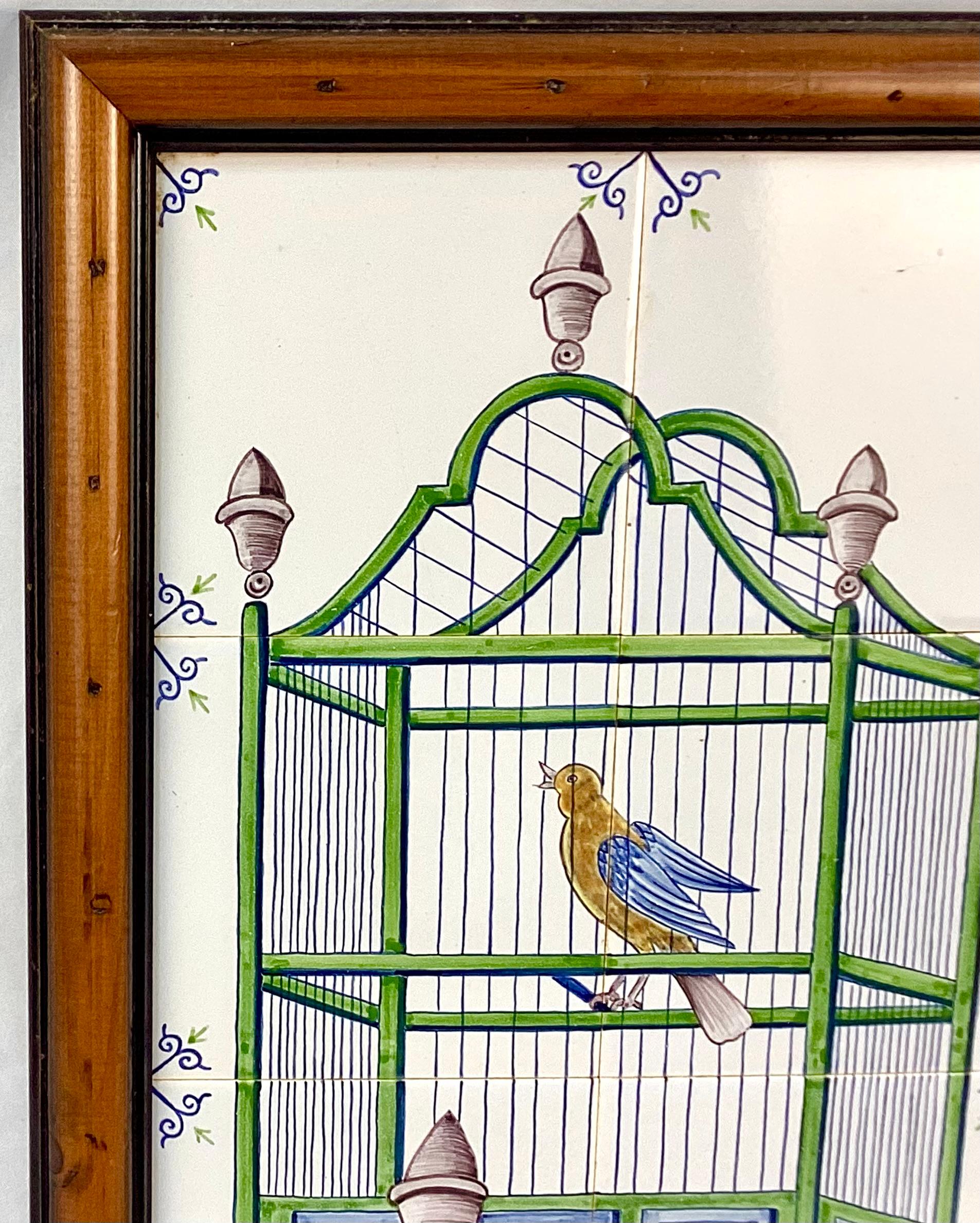 Delft 18th Century style tiles featuring a bird in a cage. Mural has six approximately 5 x 5 tiles. These are painted with a green and blue bird cage and yellow and blue bird perched inside with gray finials and a gray water bowl mounted in a custom