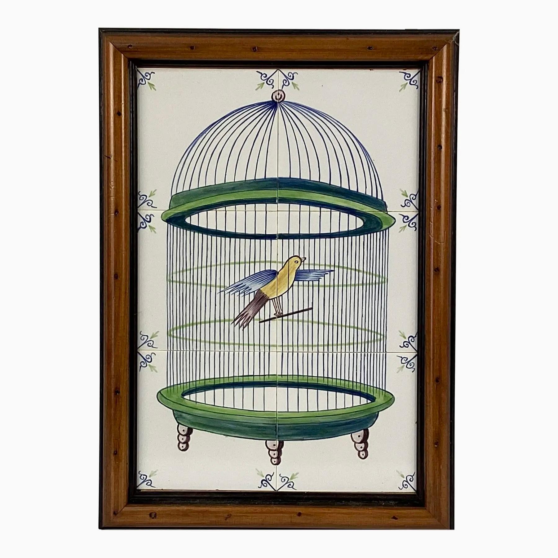 Delft 18th Century style tiles featuring a bird in a cage. Mural has six approximately 5 x 5 tiles. These are painted with a green and blue domed bird cage and yellow and blue bird perched inside. Cage has a brown finial and brown feet.  Mounted in