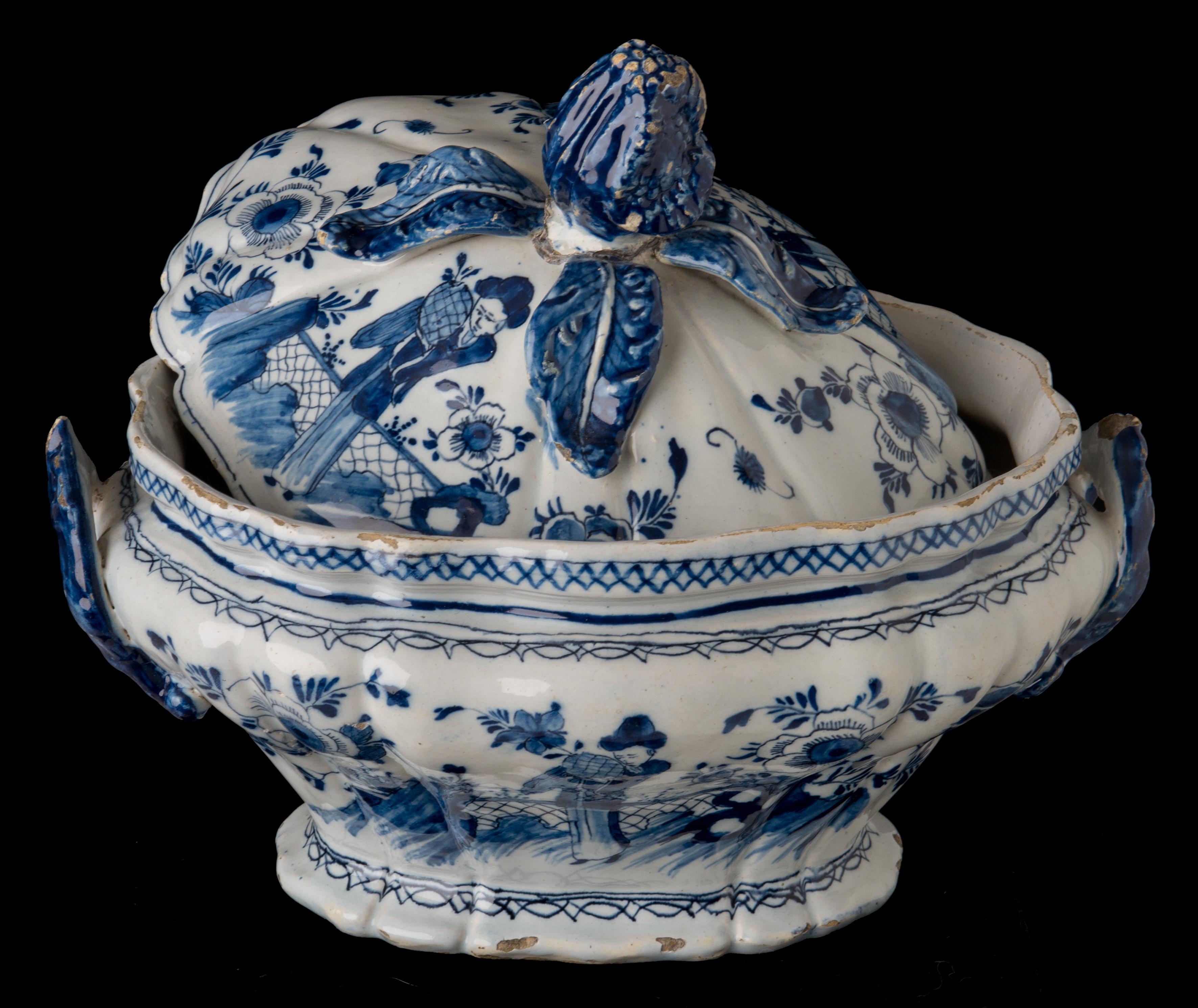 Blue and white chinoiserie tureen Delft, circa 1750
Mark: DM  

The blue and white oval-shaped tureen has a curved body on a spreading foot and two blue-coloured foliate loop handles. The knob on the cover is modelled as a flower with four leaves.