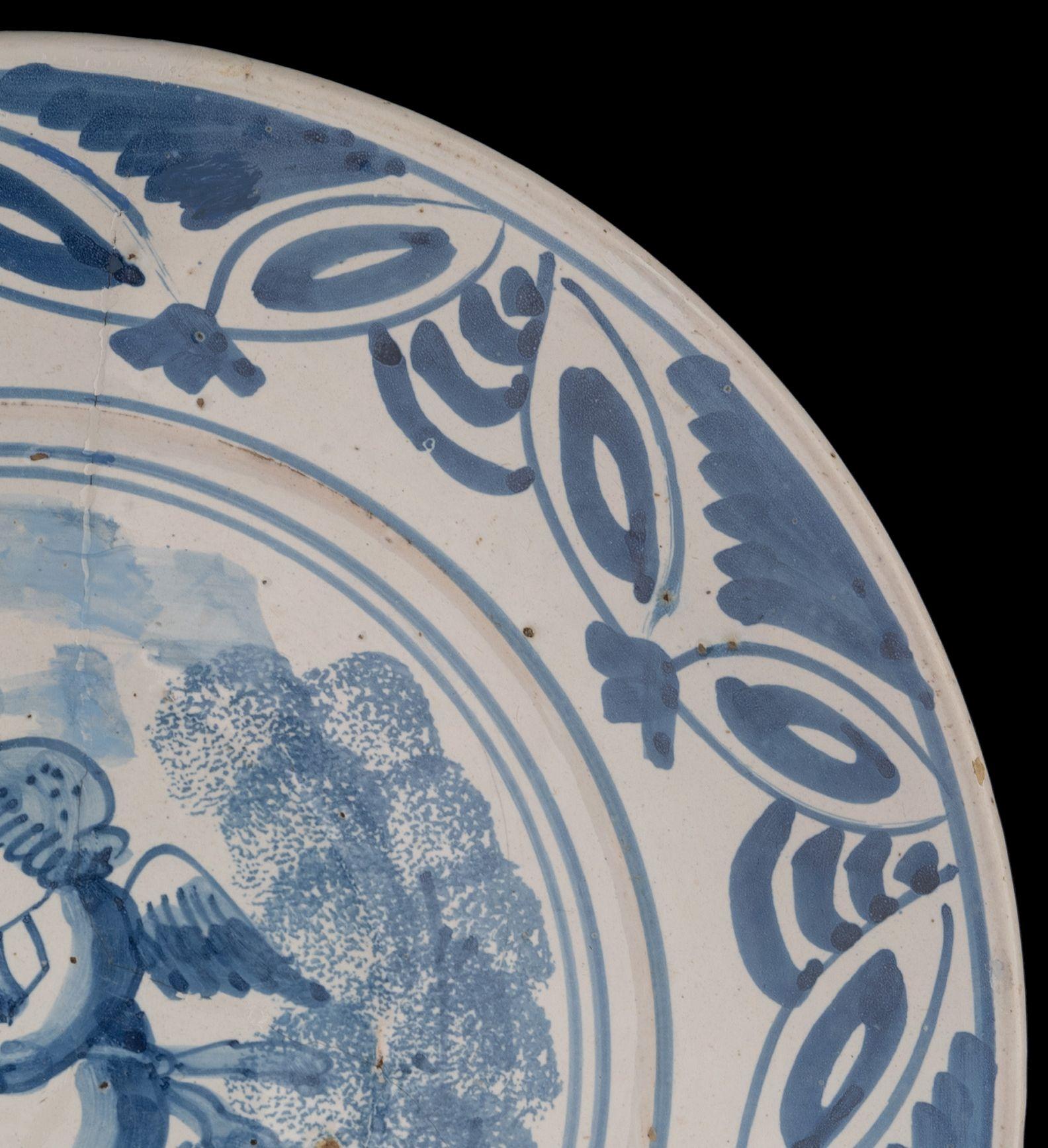 Glazed Delft Blue and White Dish with a Flute-Playing Putto, the Netherlands, 1660-1700 For Sale