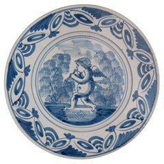 Delft Blue and White Dish with a Flute-Playing Putto, the Netherlands, 1660-1700