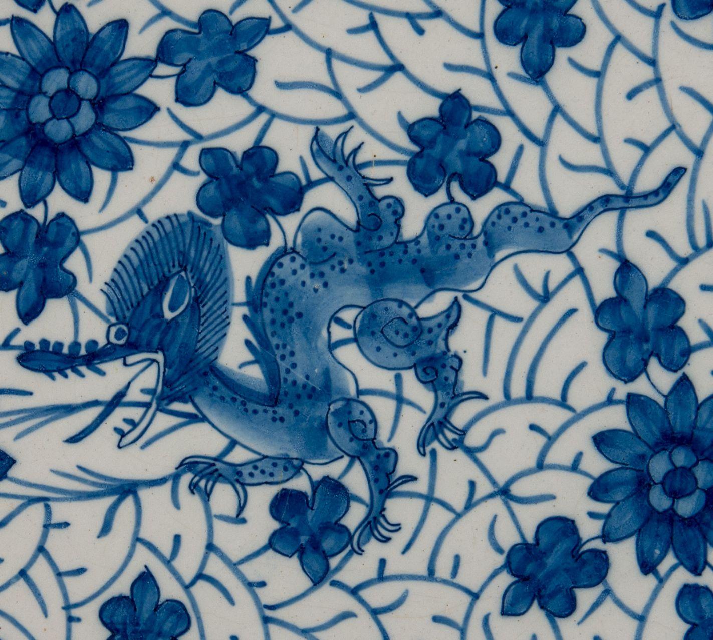 Blue and white dragon dish. Delft, 1722-1757

The Greek A pottery Mark: AIK, period J van der Kool (1722-1757)
Dish with blue and white decoration of a dragon on a dense ground of flowers and foliage. The well is undecorated. The border is