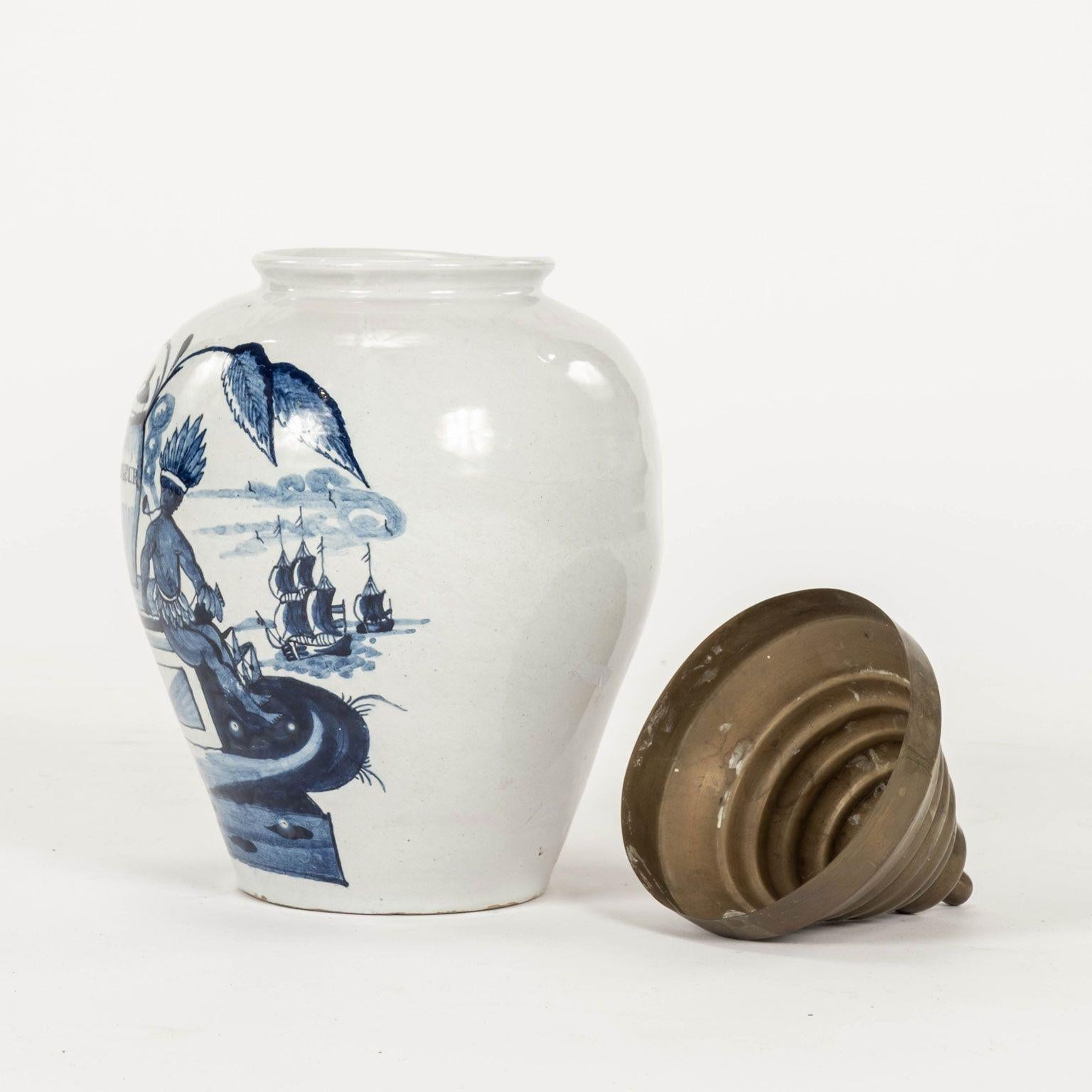 Delft blue and white “Rosegeur” urn-shape tobacco jar with lid, Netherlands, circa 1780. Inscribed “Rosegeur” and decorated with coastal scene and seated “Amerindian” figure. Rosegeur, or Rozengeur, refers to rose scented tobacco favored for use