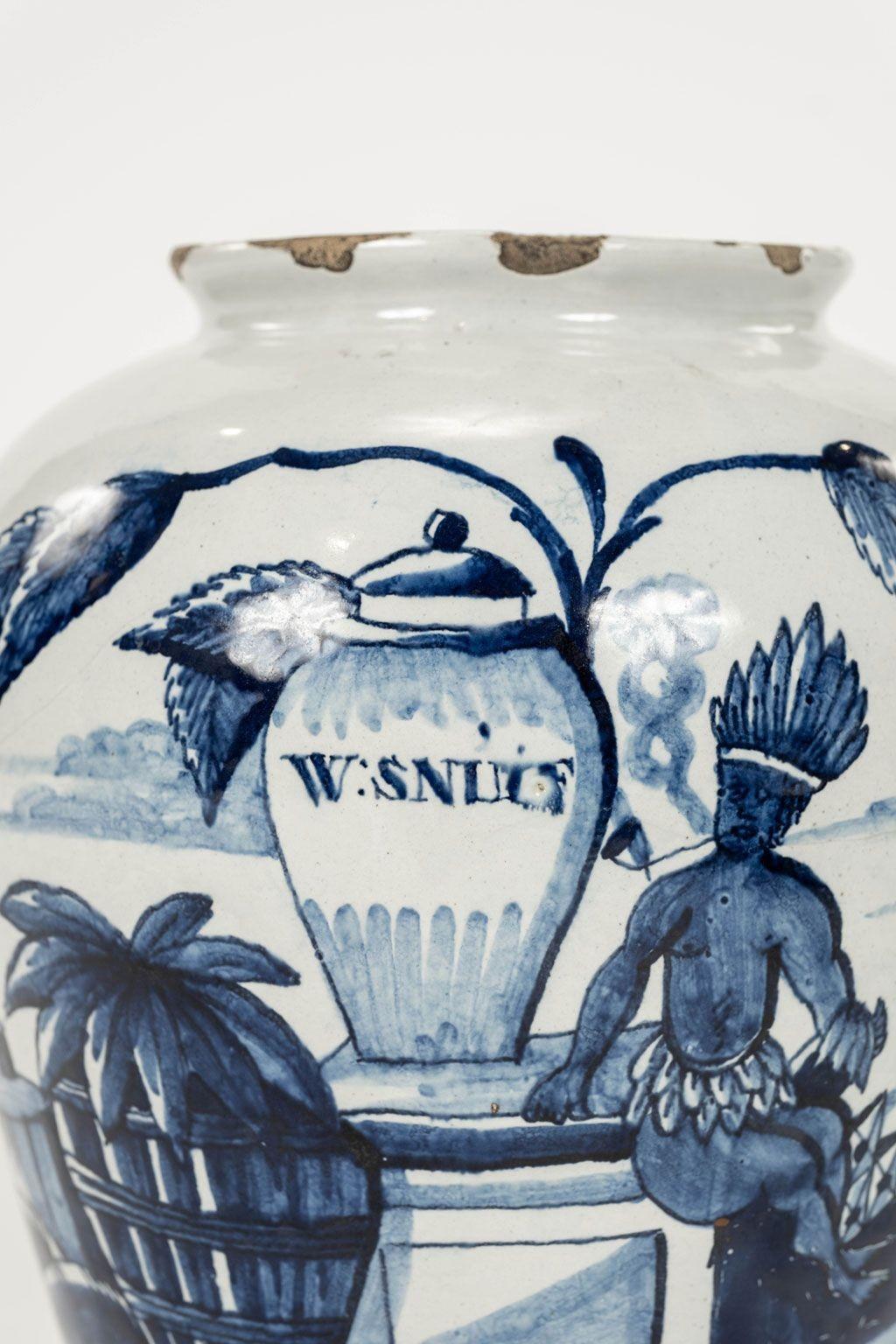 Delft blue and white “W:Snuif” urn-shape tobacco jar with lid, Netherlands, circa 1780. Inscribed “W:Snuif” and decorated with coastal scene and seated “Amerindian” figure. W:Snuif refers to finely ground snuff tobacco commonly inhaled throughout