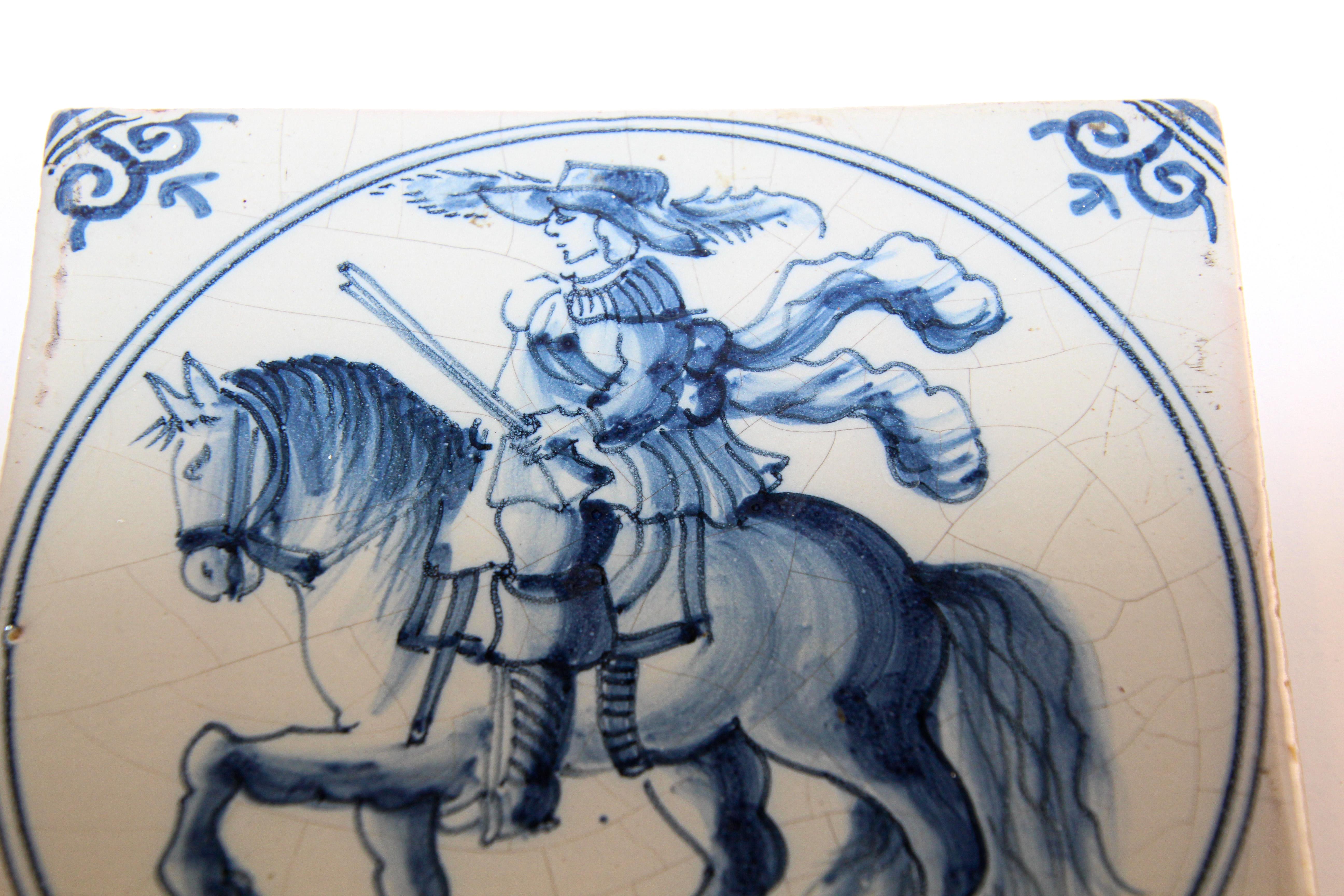 Vintage Delft tile featuring a noble man riding a horse. 
This characterful Delftware tile a man on horseback in expressive blue coloring on a white background. 
Hand painted, Dutch (Netherlands), delft ceramic wall tile in blue and white