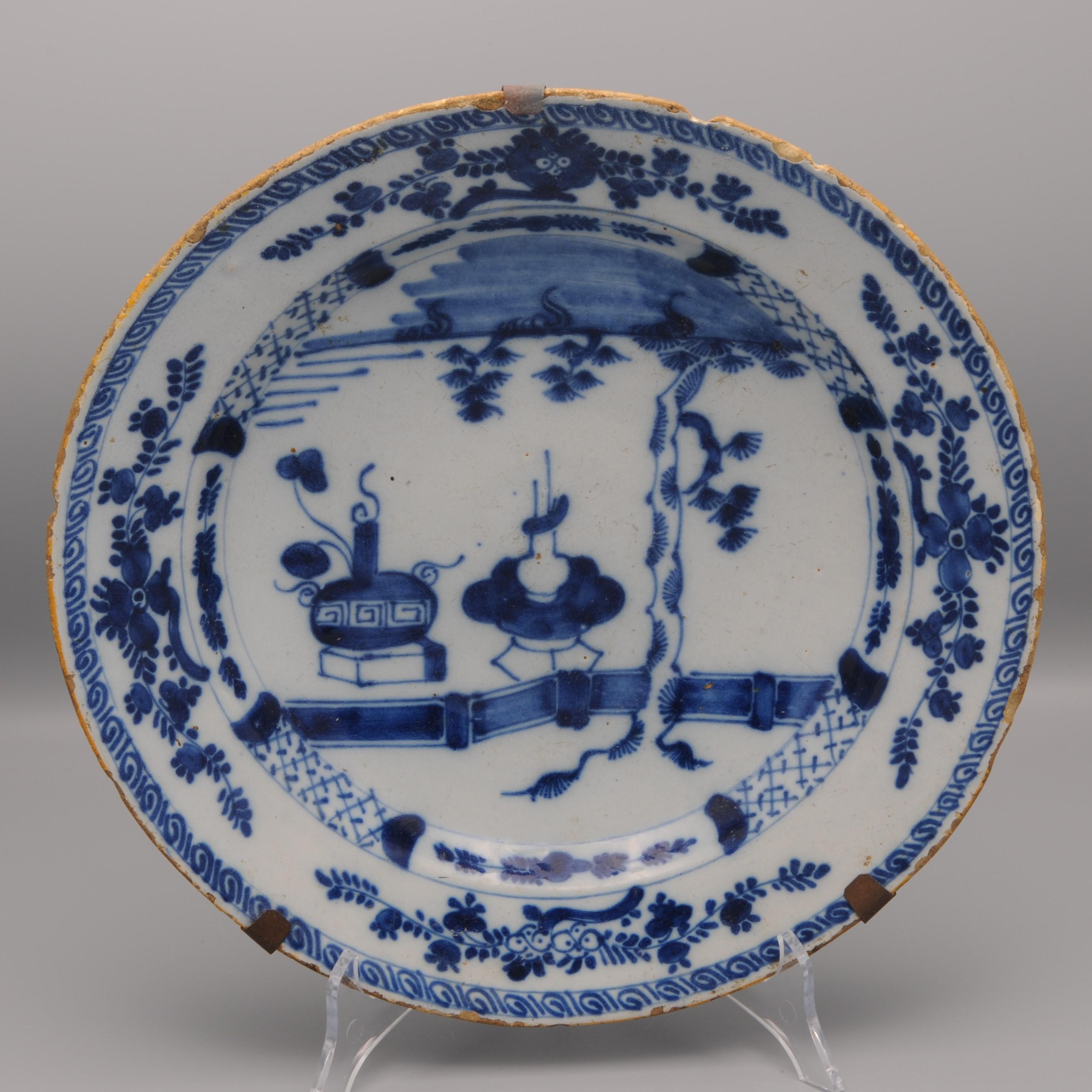 Mid 18th century Blue Delftware charger with Chinoiserie decor of 'precious gifts'.
Marked 'De Claauw' 
Mid 18th century 
Good quality of painting
Good condition; chips and usual wear to the rim