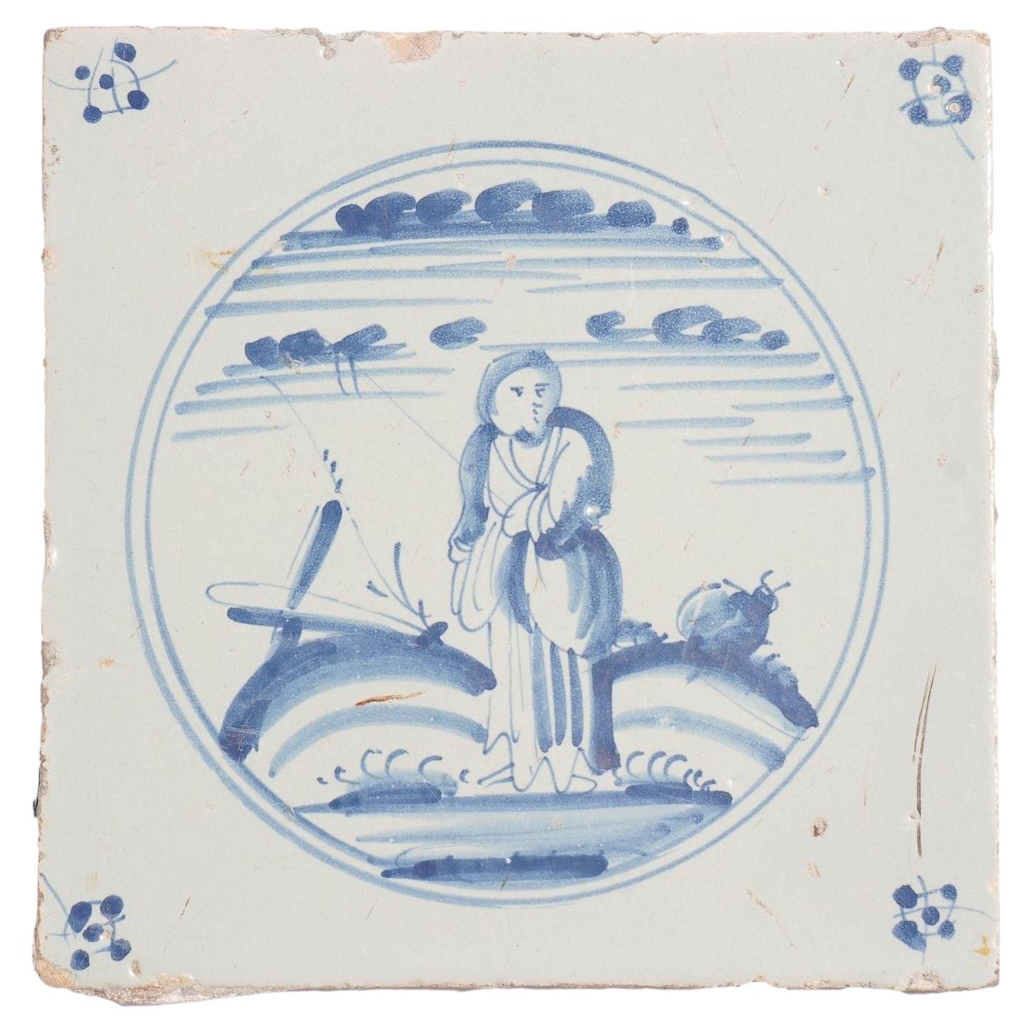 Delft faience tile of a girl in a landscape, c. 1700’s