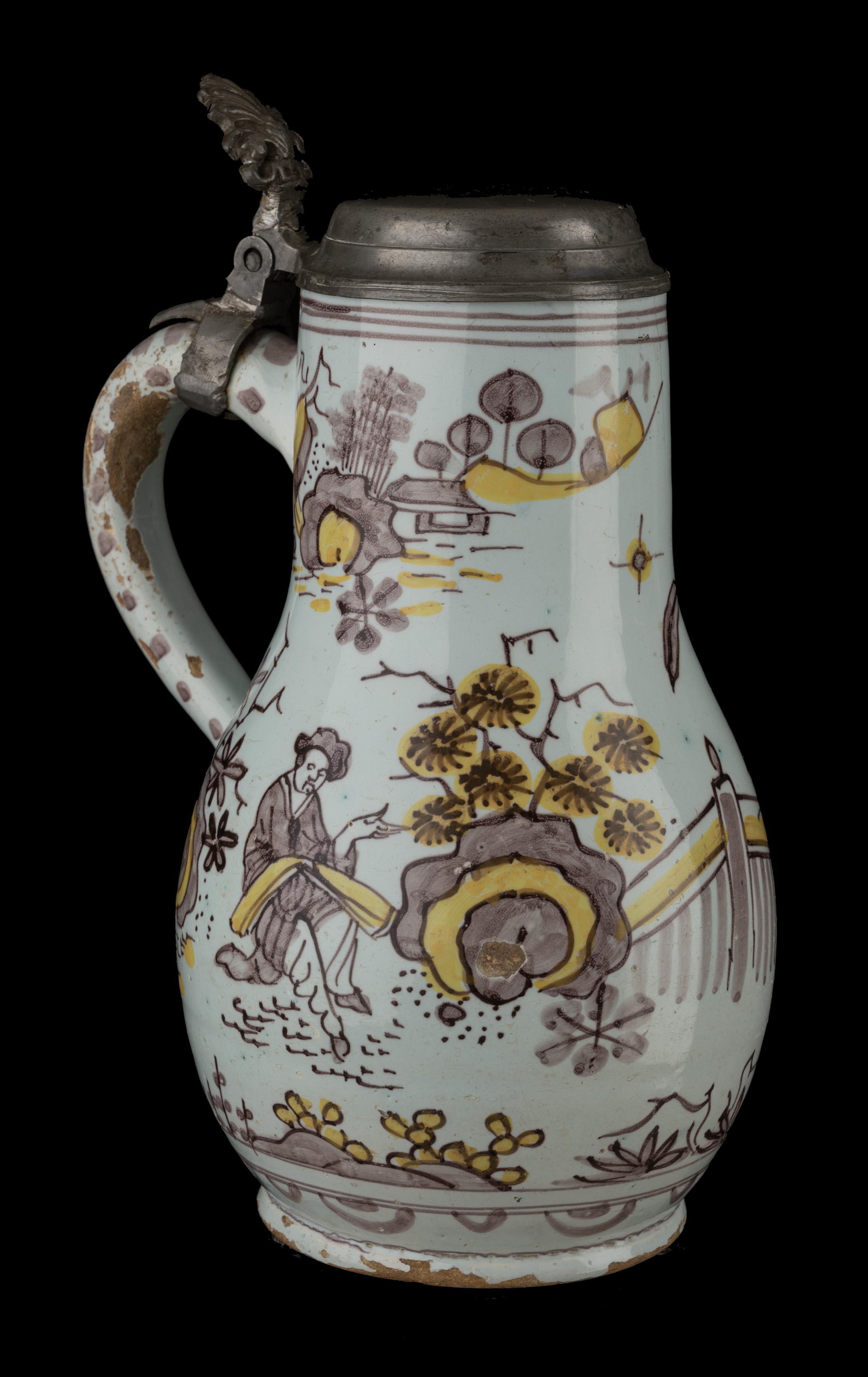 Polychrome chinoiserie beer mug
Delft, 1680-1690

Dimensions: height 26,5 cm / 10.43 In (with cover) 

The pear-shaped beer mug stands on a slightly-waisted foot and has an ear-shaped handle that ends in a rat tail. A garden-like oriental landscape