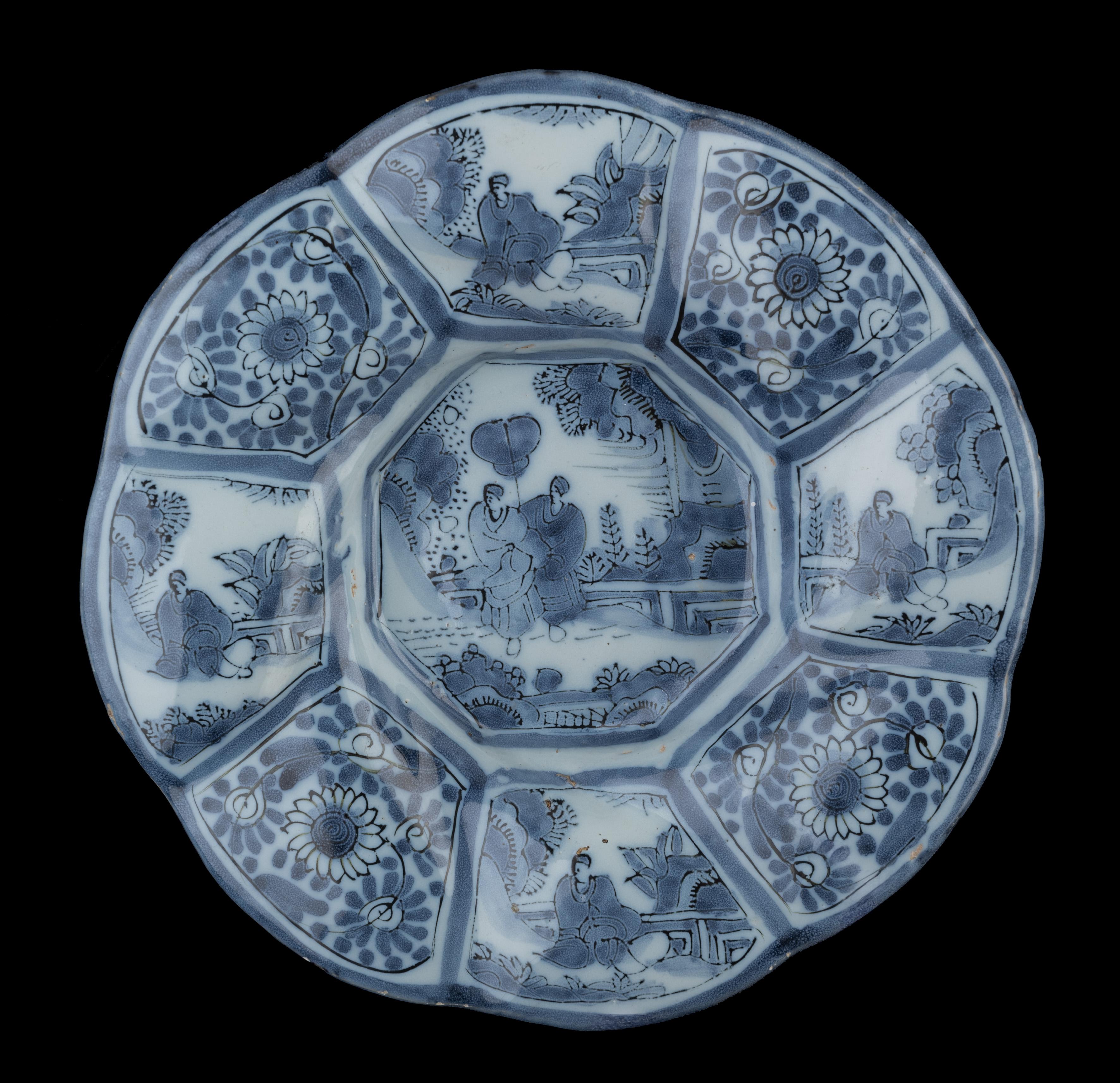 Pair of blue and white chinoiserie lobed dishes. Delft, 1680-1700
Dimensions: diameter 30 cm / 11.81 in each.

The lobed dishes are composed of eight wide and twisted lobes and are painted in blue with a chinoiserie decor. Two sitting Chinese