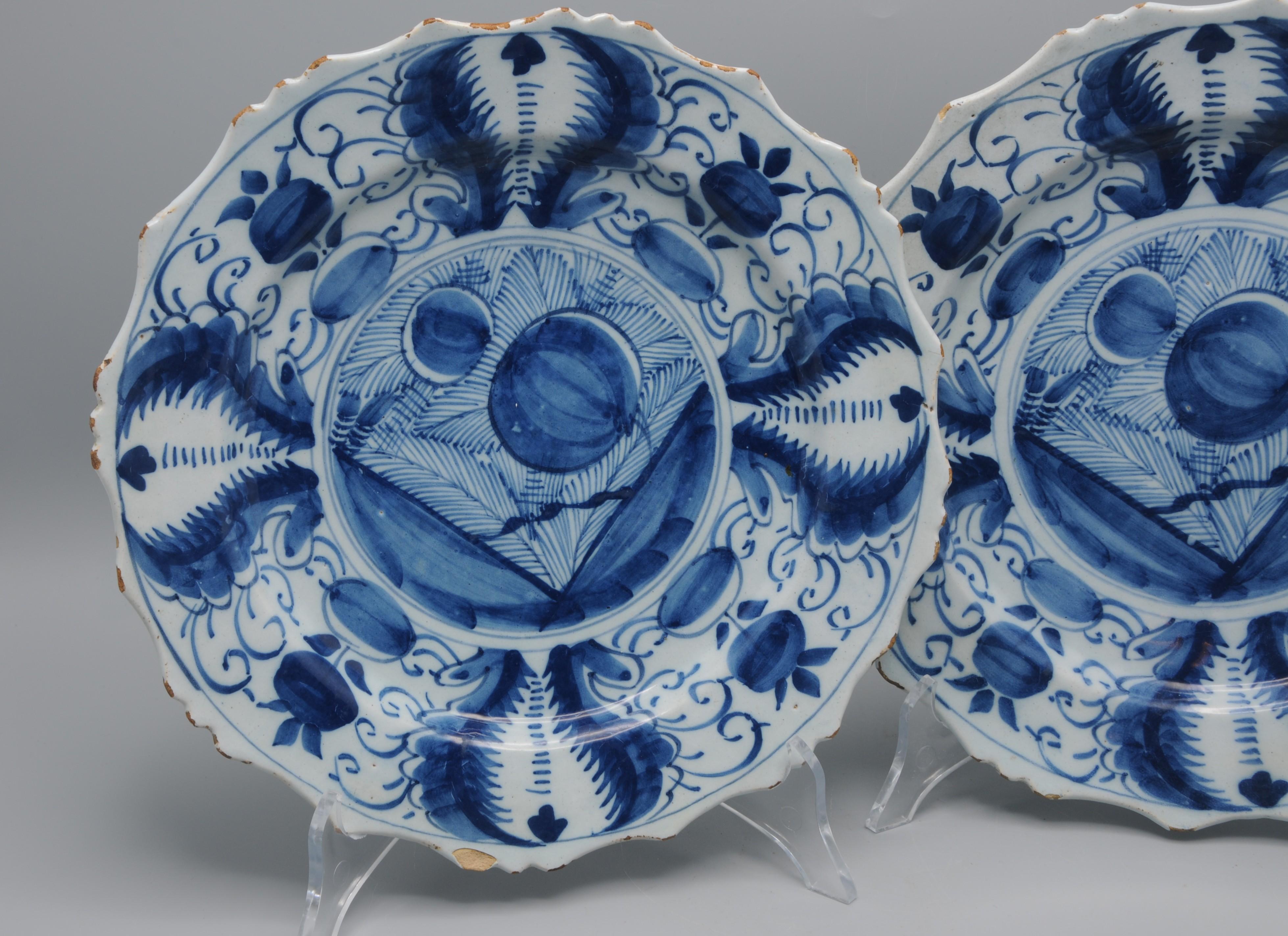 A fine pair of Dutch Delft faience plates with scaloped rim, dating to the 18th century, hand-painted in cobalt blue on a tin-glazed white ground, inspired on Chinese porcelain. 

The plates display the timeless appeal of Delftware: a balance of