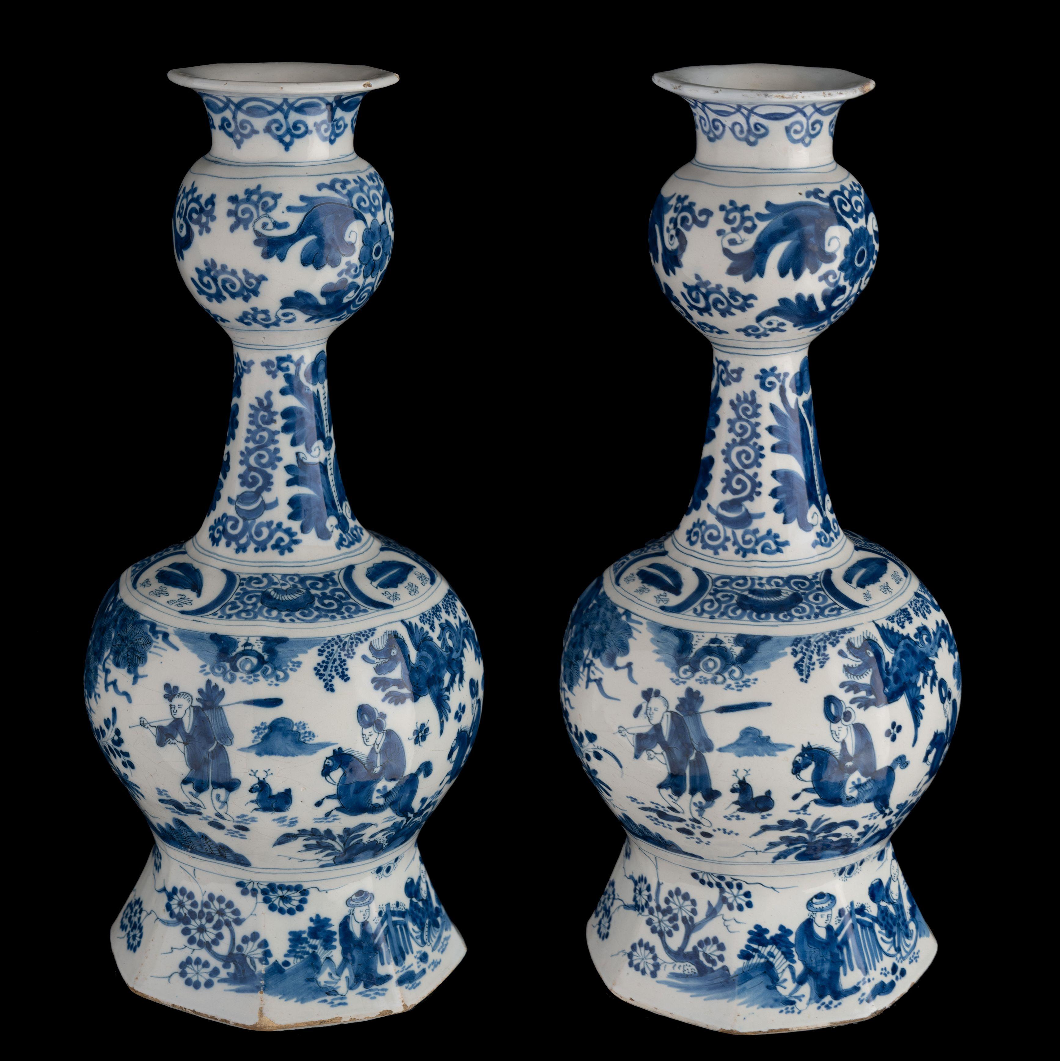 Pair of blue and white garlic-head chinoiserie bottle vases. Delft, 1680-1690 

The octagonal garlic-head vases stand on a wide, spreading foot and are painted in blue with a chinoiserie decor. An oriental landscape with buildings, a Chinese