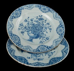 Delft Pair of blue and white plates with flower vases dated 1760