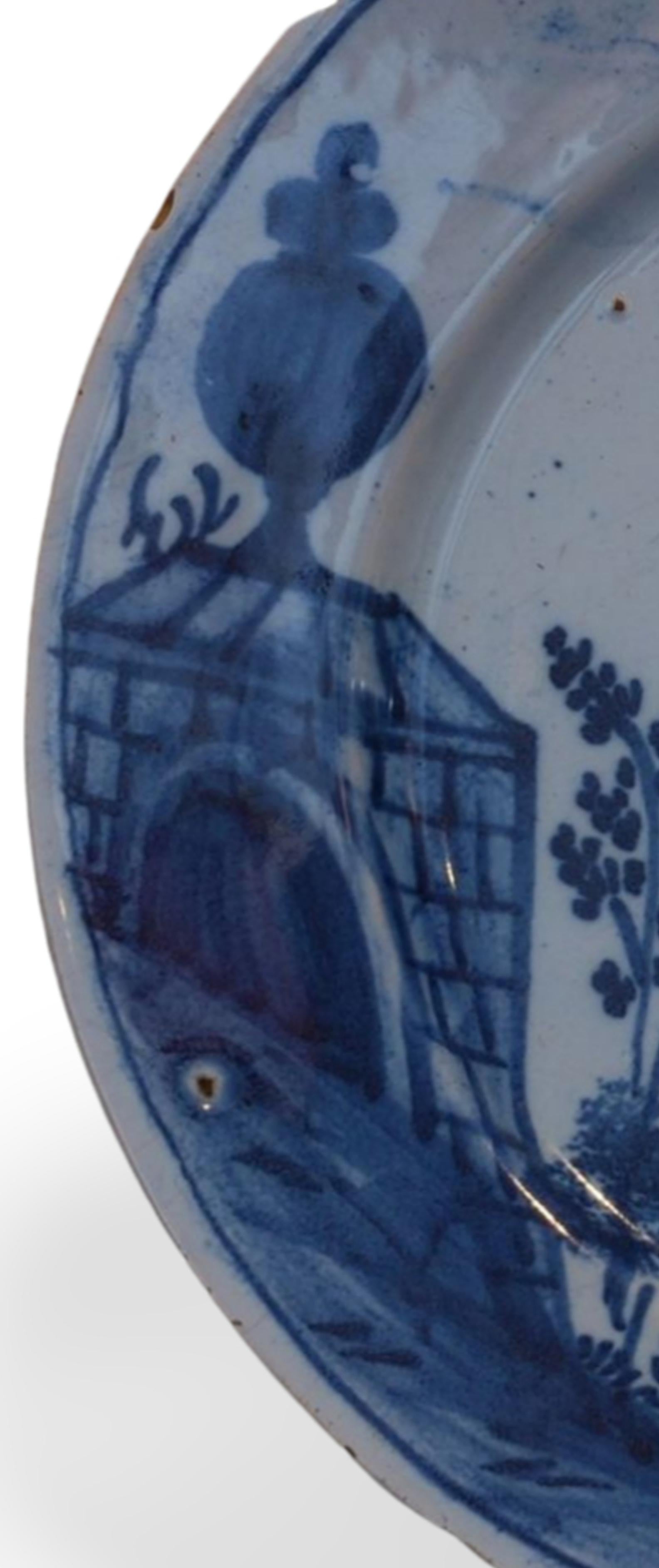 English Delft plate with a woman passing a monument. England C1745. For Sale