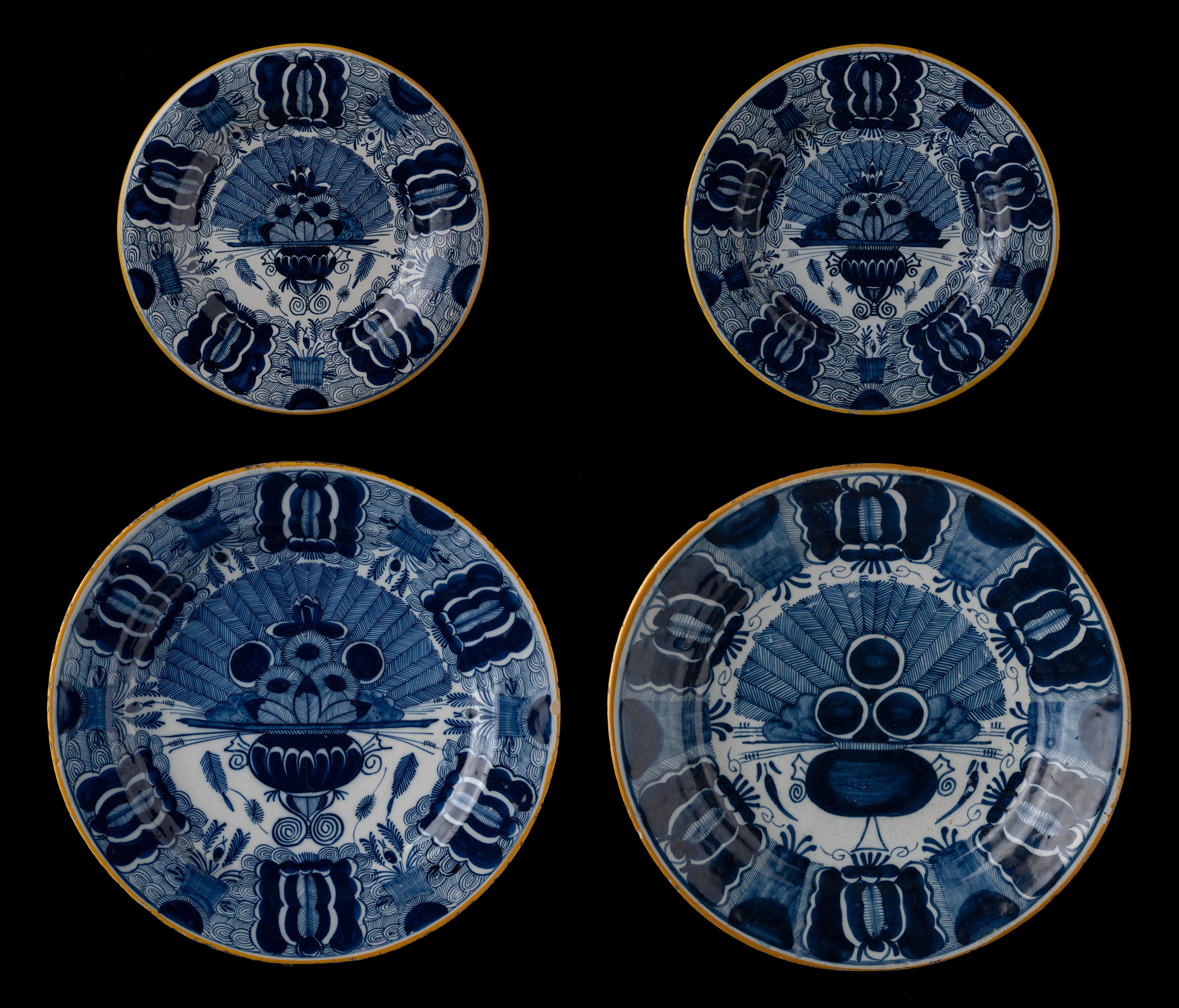 A set of two peacock design Delft plates, and two larger Delft dishes. All hand-painted with 