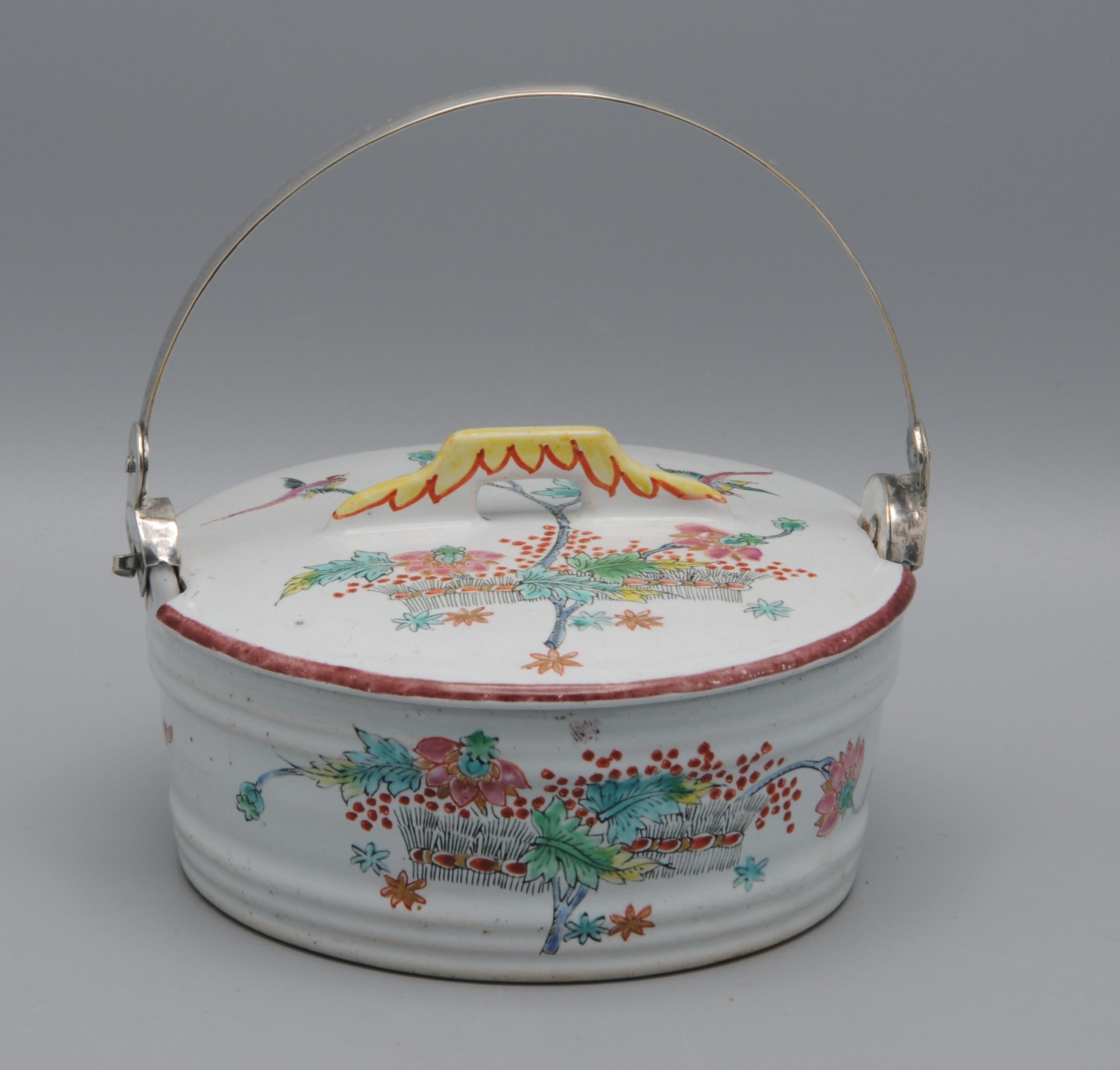 A fine Dutch Delft polychrome earthenware butter dish with domed cover, decorated in the Japanese Kakiemon style. The round form is painted with birds among flowering branches, executed in a vivid palette of red, green, blue, and yellow