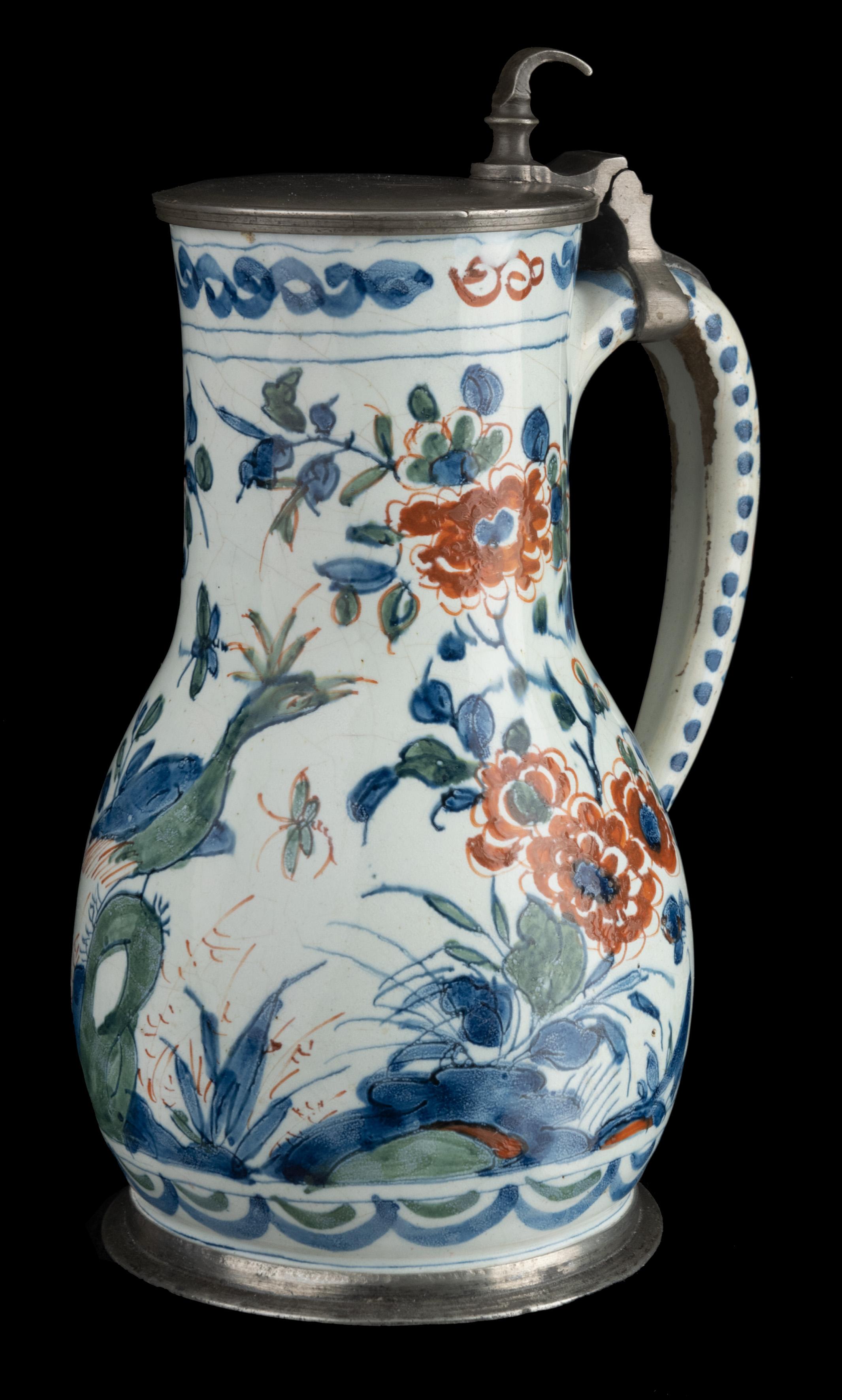 Polychrome cashmere beer mug with pewter lidDelft, 1700-1710

The pear-shaped beer mug with pewter lid stands on a short waisted foot and has an ear-shaped handle that ends in a rat tail. The beer mug is painted in blue, green and red with a peacock