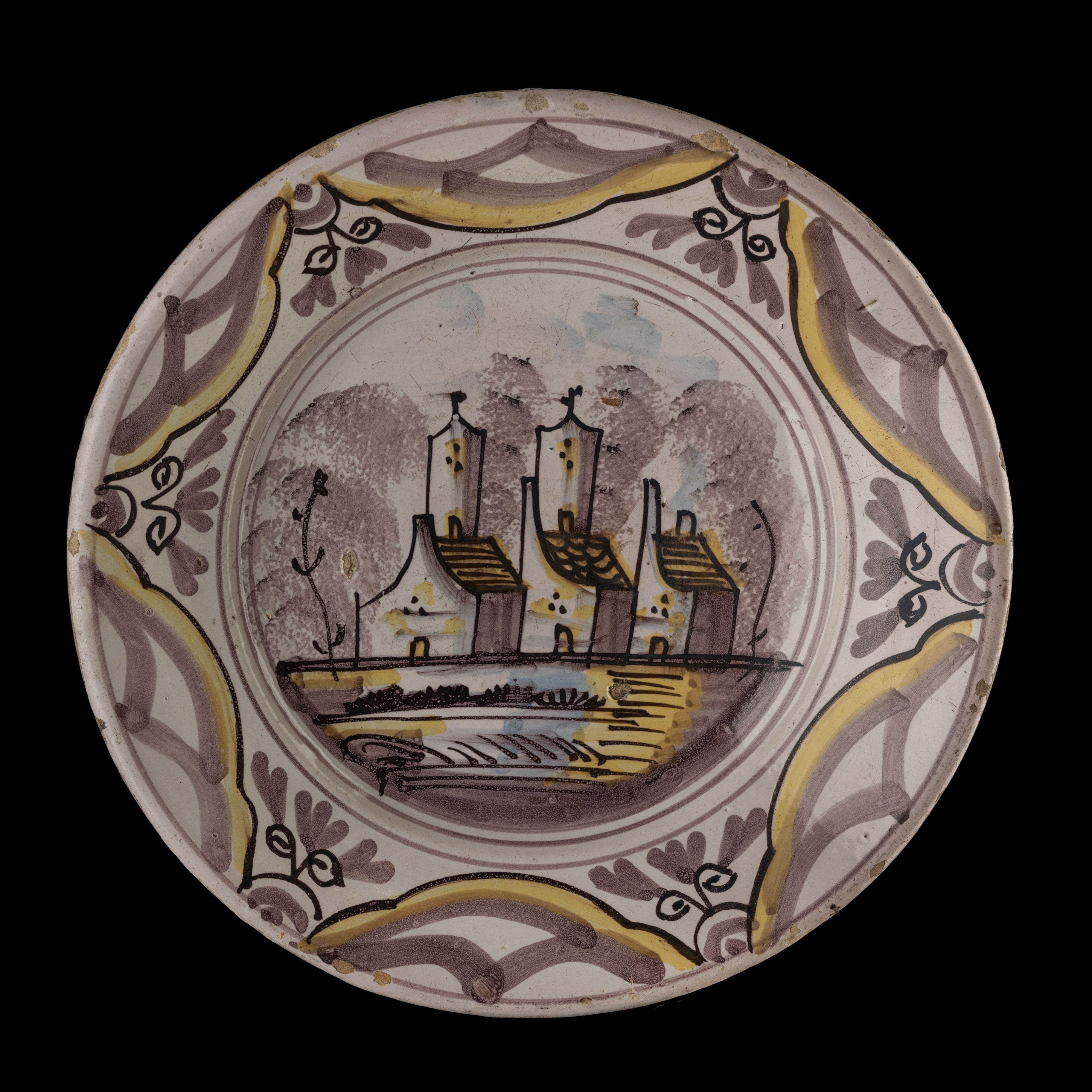 Polychrome dish with a village view The Netherlands, 1675-1725.

The dish has a spreading, slightly raised flange and is painted in blue, purple and yellow with a simplified village view in a double circle. A ornamental decor of arched segments
