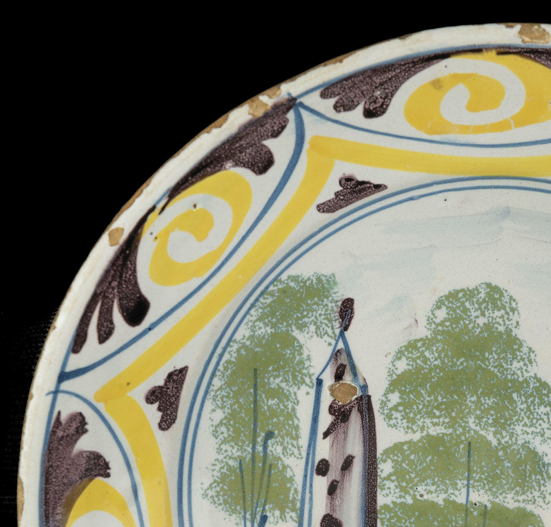Dutch Delft Polychrome majolica dish with a village view The Netherlands, 1700-1750  For Sale