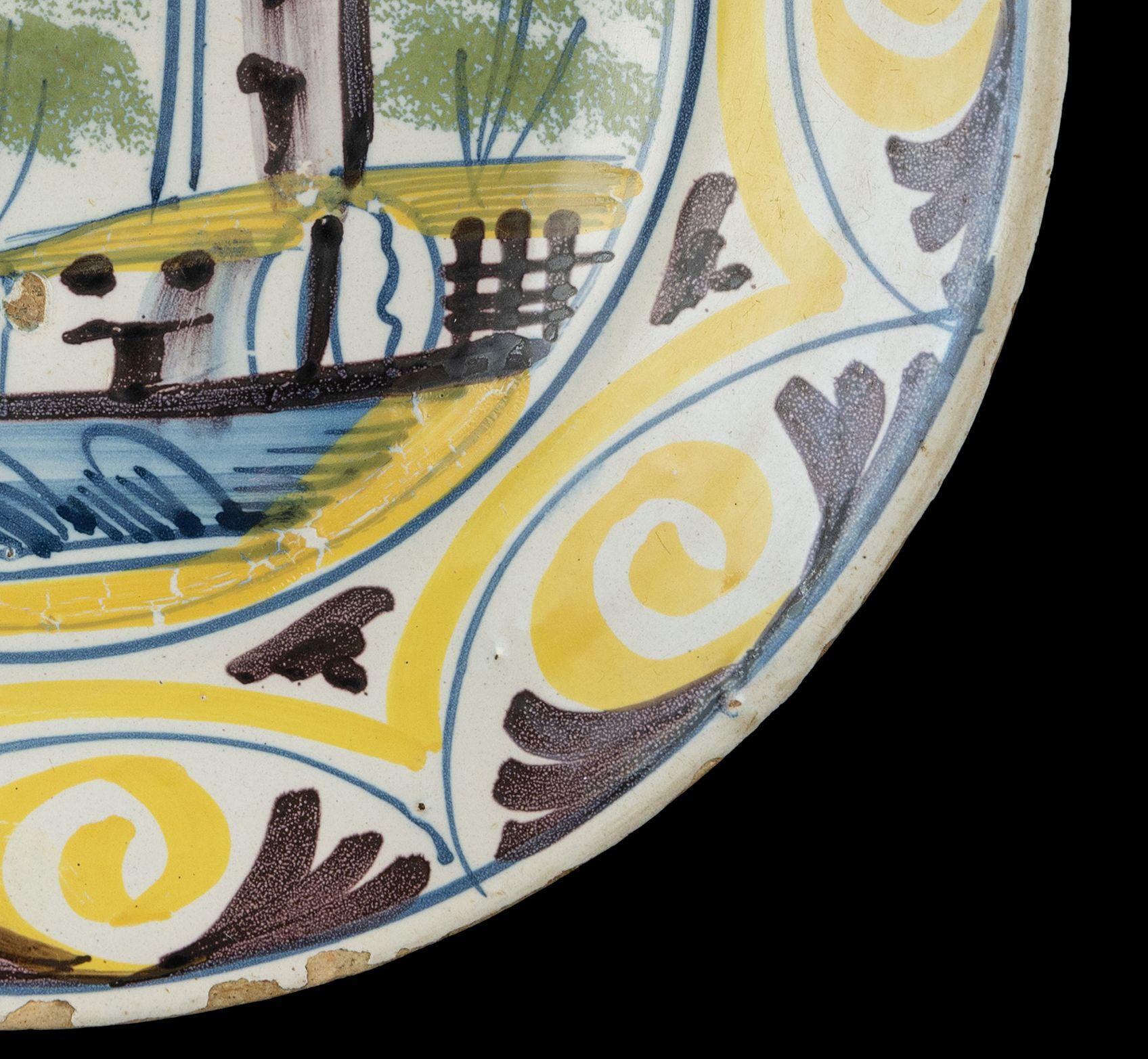 Delft Polychrome majolica dish with a village view The Netherlands, 1700-1750  In Good Condition For Sale In ROSSUM, GE
