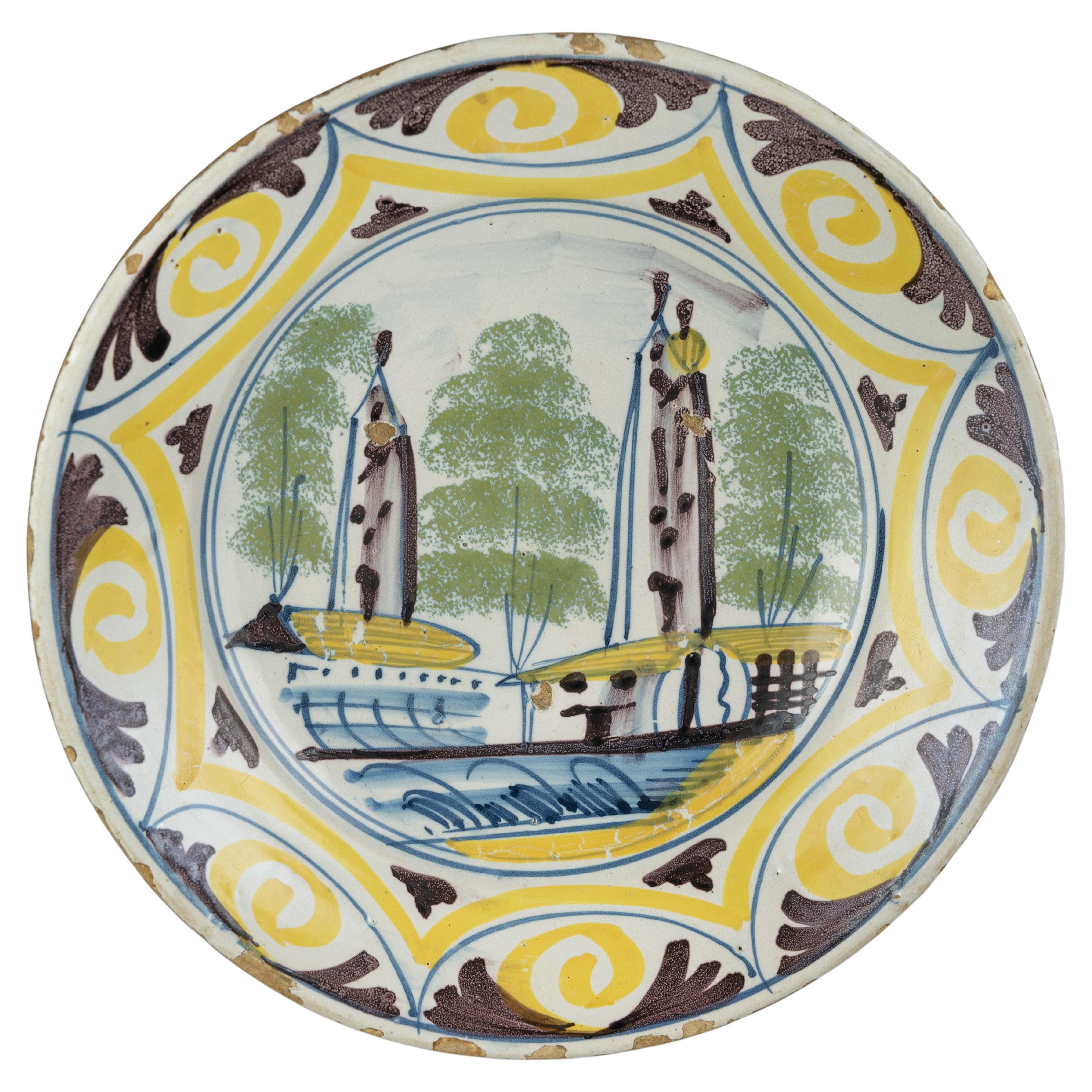 Delft Polychrome majolica dish with a village view The Netherlands, 1700-1750  For Sale