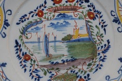 Delft polychrome plate depicting a landscape with ships - 18th century