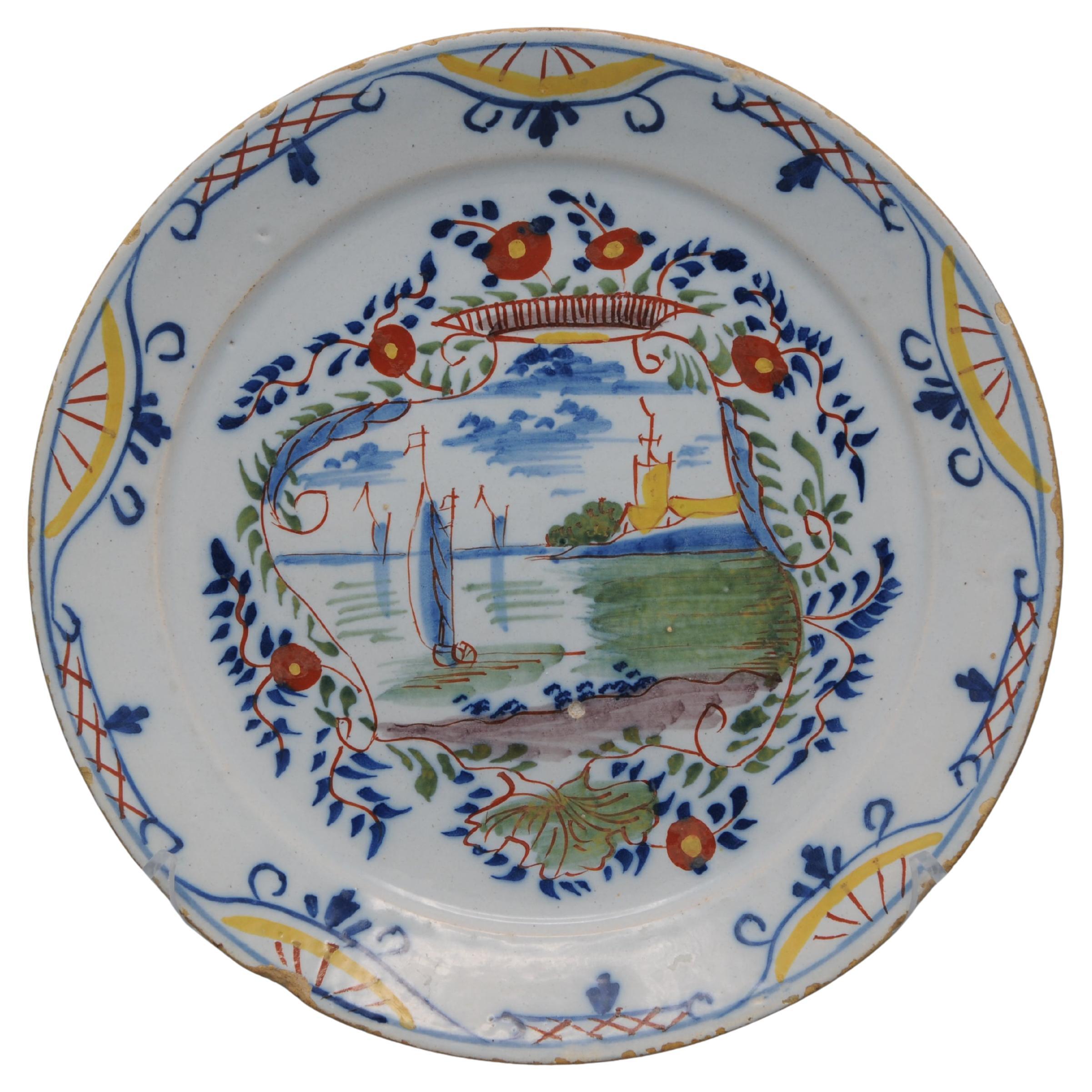 Delft polychrome plate depicting a landscape with ships - 18th century