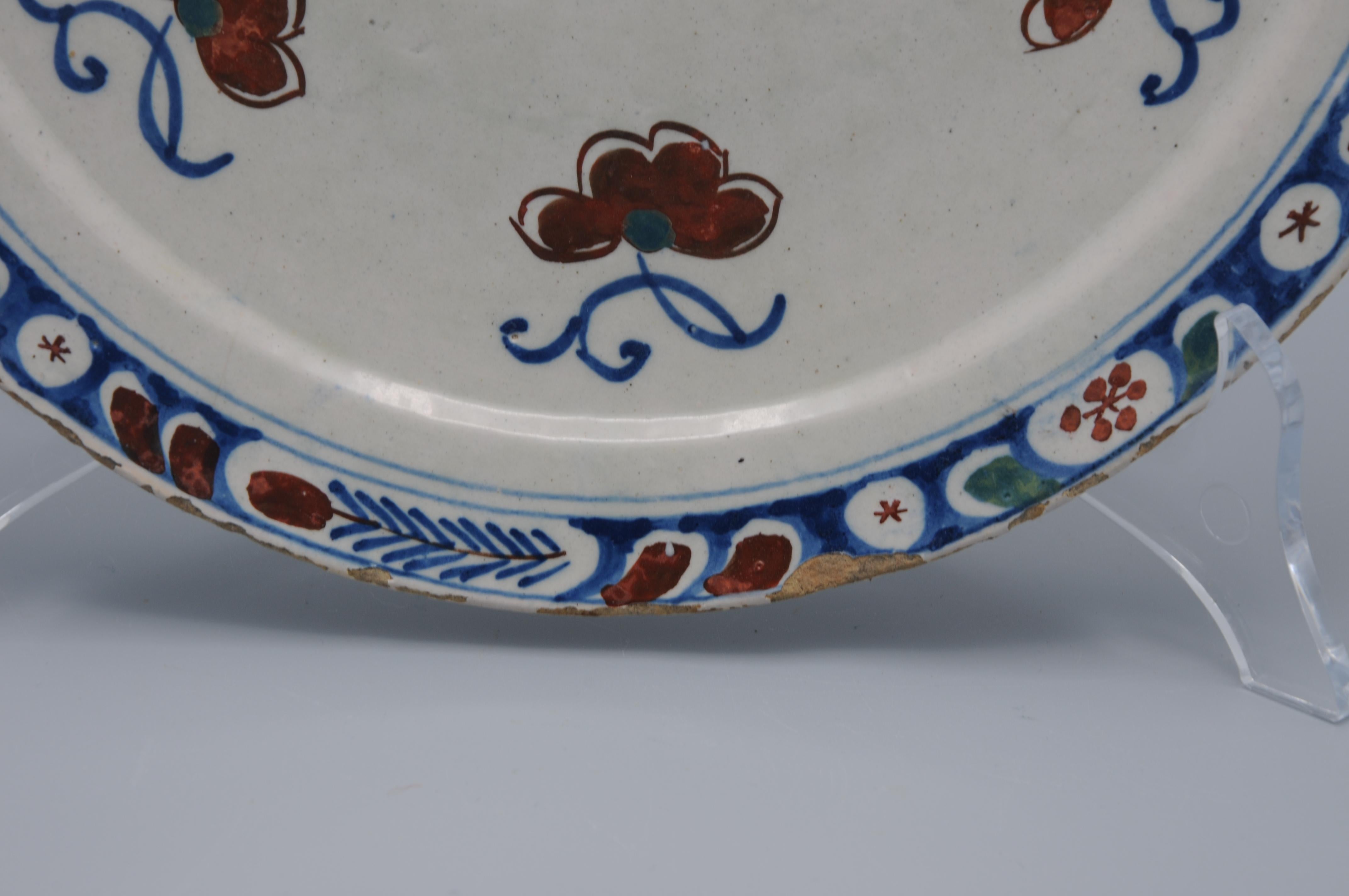 Vernissé Assiette polychrome de Delft avec papillon - première moitié du 18e siècle en vente