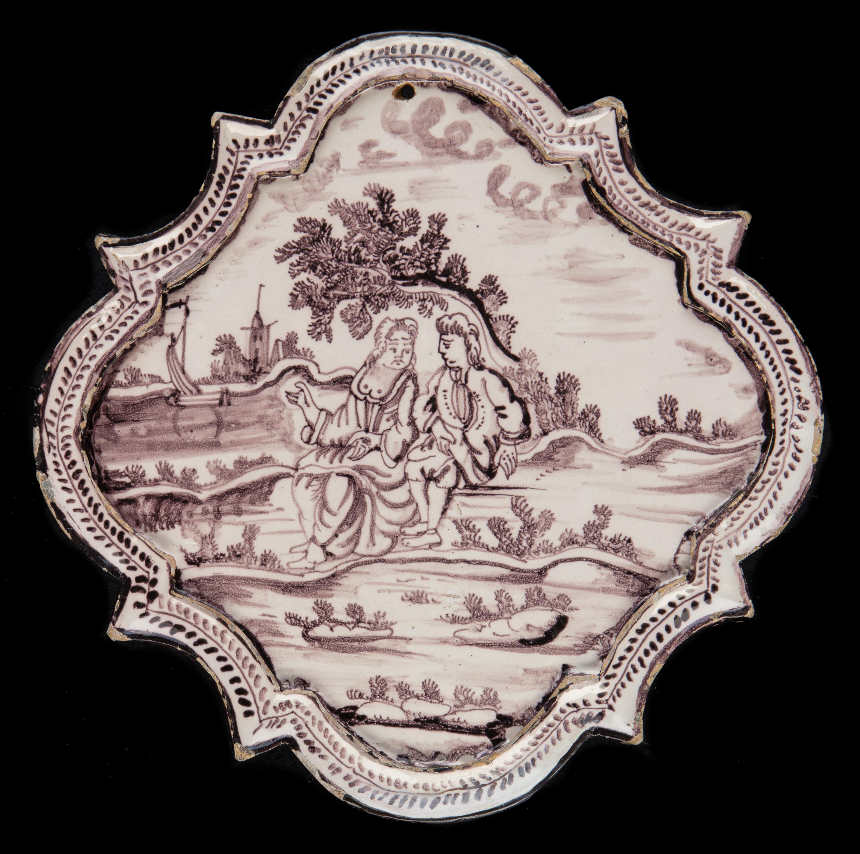 Purple and white plaque with figures in a landscape. Utrecht circa 1760

Lozenge-shaped purple and white plaque with a conversing couple in a landscape. In the foreground a man and a women with a bare bosom sit on a river bank, behind them stands a