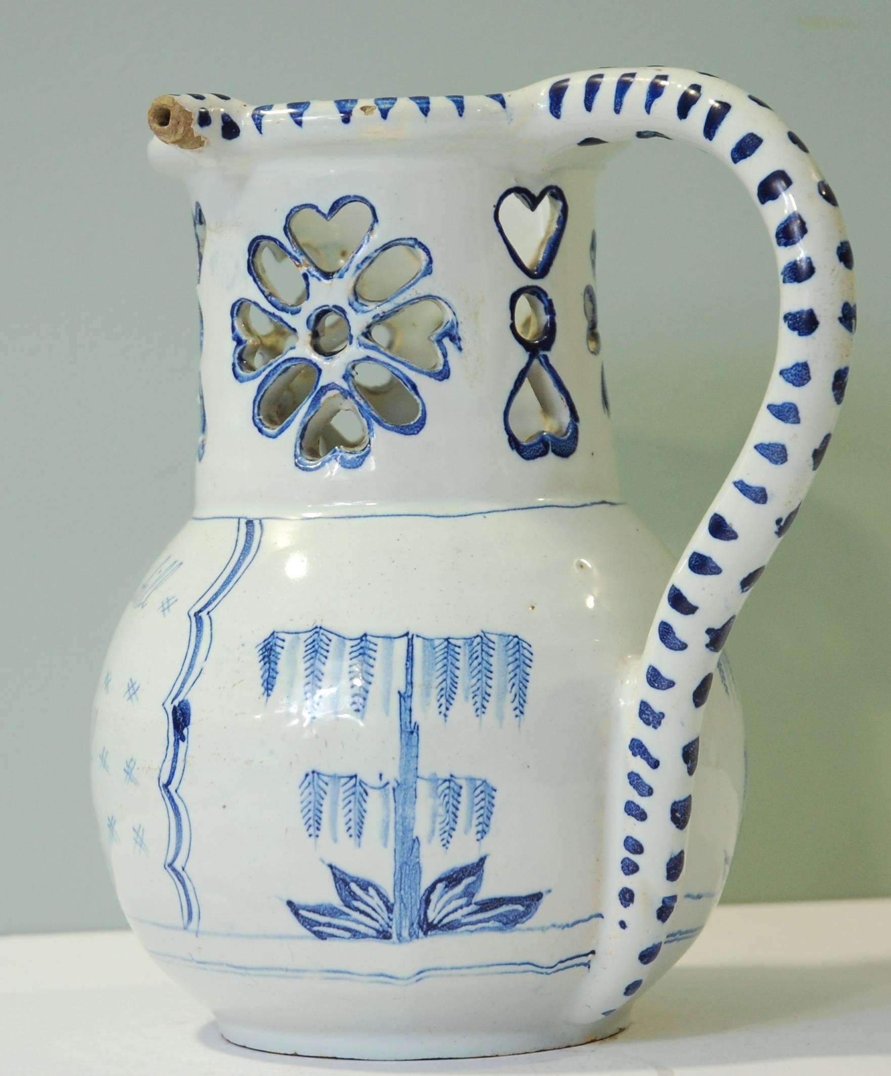 A rare delftware puzzle jug in tin-glazed earthenware, nicely painted with the usual verse. Exceptional condition. Probably Liverpool.

Puzzle jugs were a betting game popular from time to time in English pubs. You would bet someone they could not