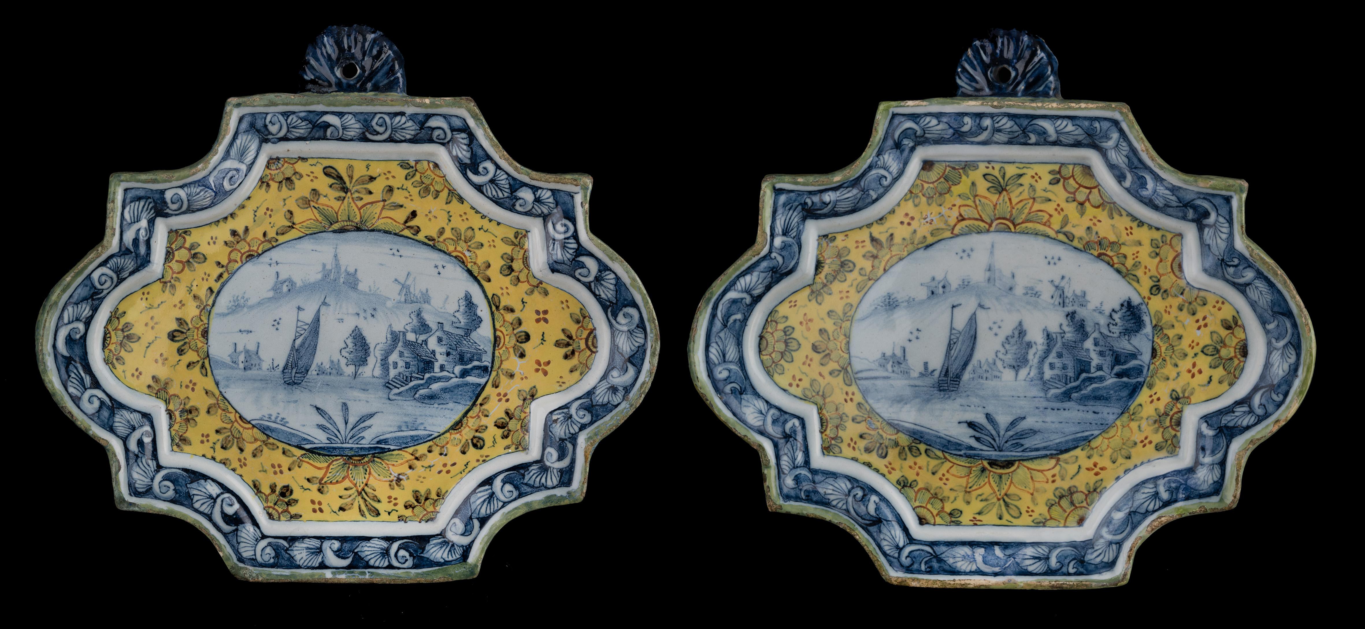 Two polychrome plaques with landscapes. Delft, 1750-1770

The plaques have a rectangular shape with indented corners and semi-circular sides. The rim is modelled in relief and has a semi-circular, profiled suspension loophole at the top. A blue and