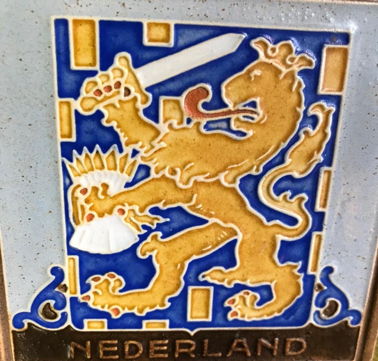 A colorful tile made by delft in the Netherlands.

Stamped 