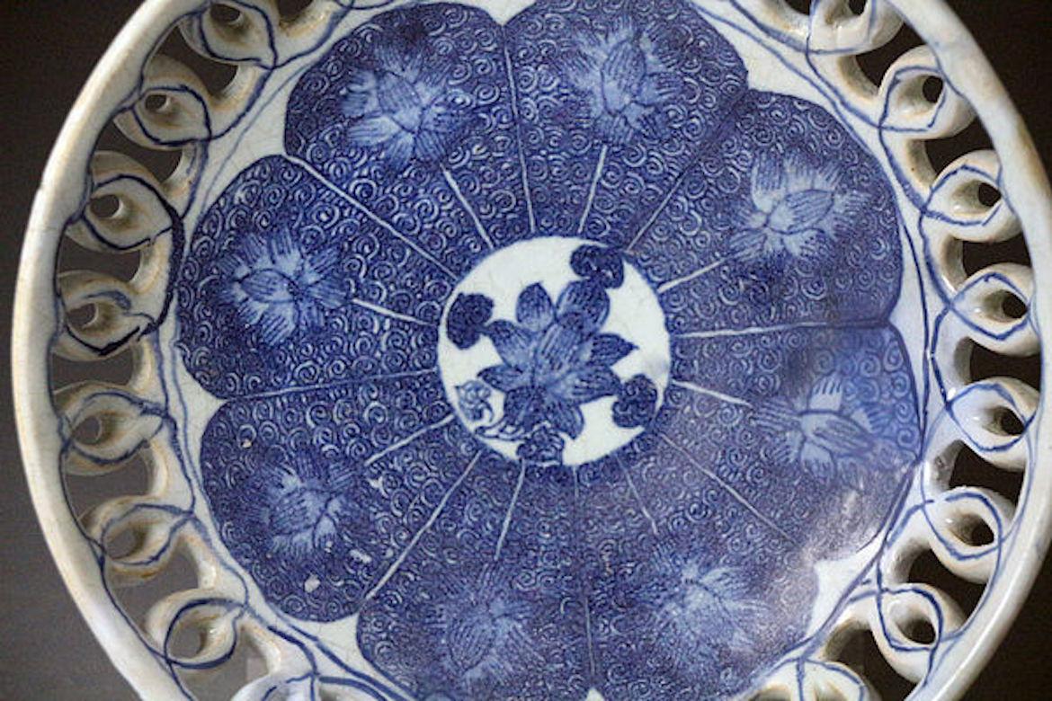 Dated: 1760, London, England

English pottery delftware bowl with pierced sides decorated in blue and white with, an unusually direct copy of a Chinese pattern of lotus leaves which was produced in the Yongzheng period(1723-1735). The dish is