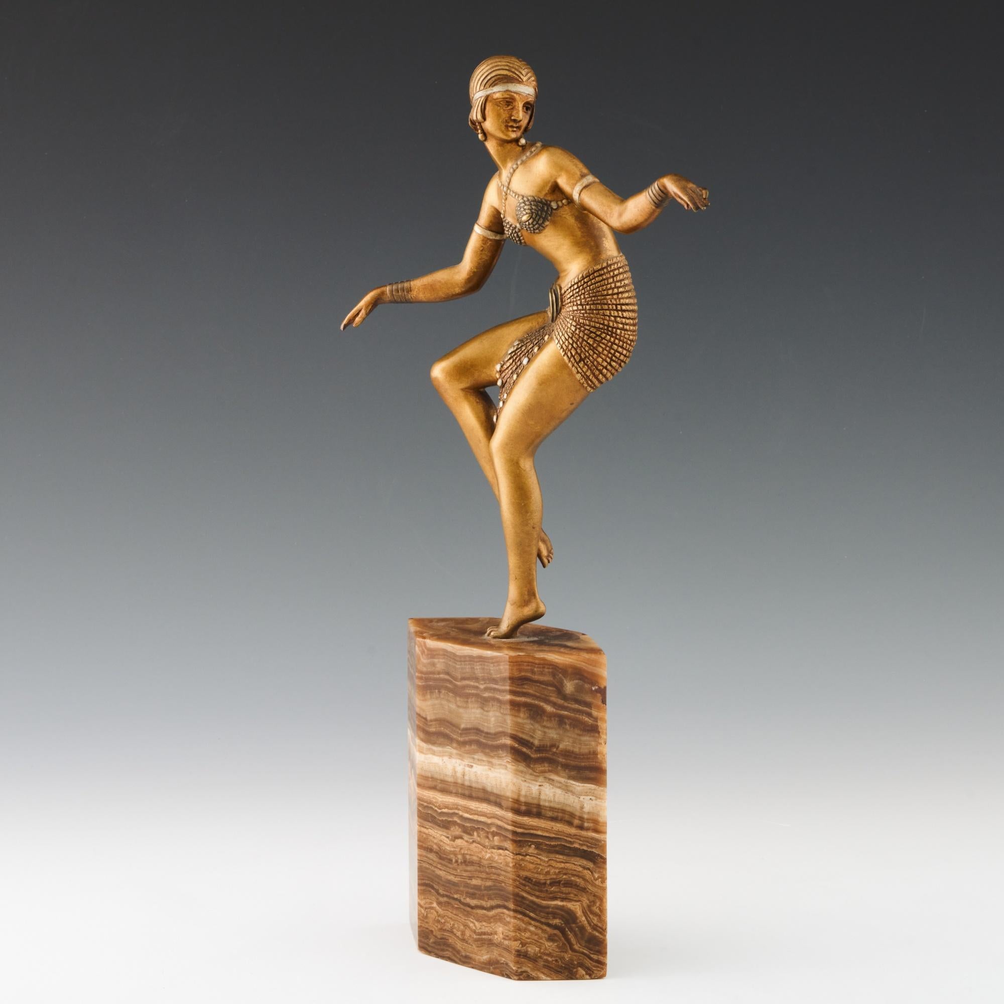 Delhi Dancer' an Art Deco cold painted gilt bronze figure by Demetre Chiparus (1886-1947). An athletic dancer dressed in scantily clad theatrical costume with arms outstretched caught in motion with one leg raised. Excellent hand finished detail and