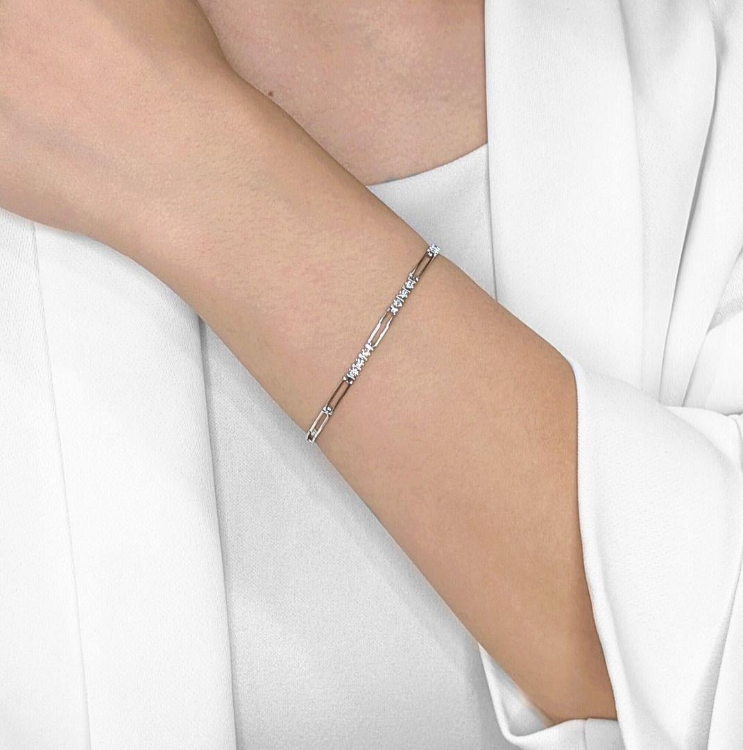 Adorn your wrist with the subtle sparkle of this delicate 10K white gold bracelet, a charming piece designed for everyday elegance. Nine brilliant natural round diamonds, totaling a dainty 0.09ct, are meticulously set to add a touch of understated