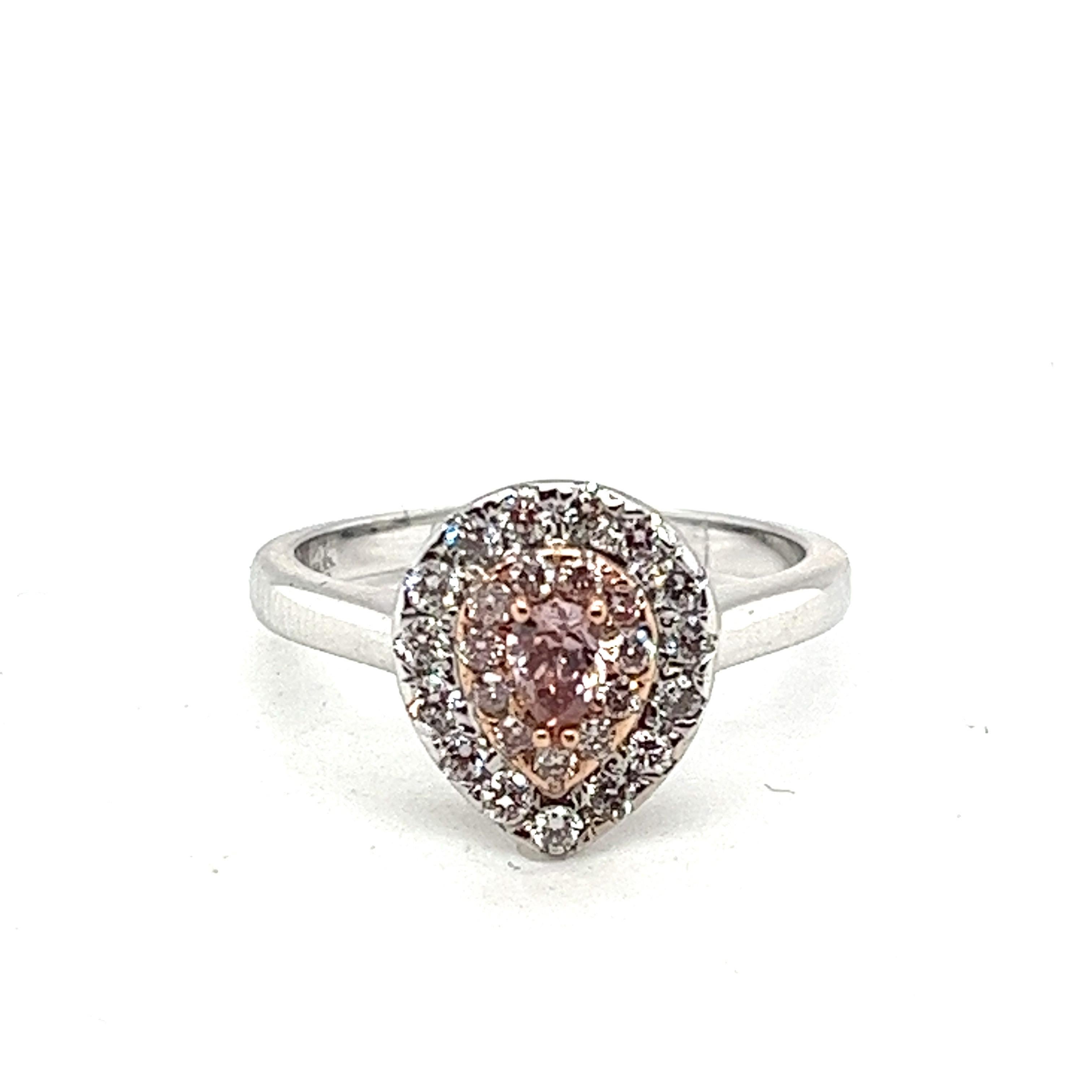 Elegance takes a captivating form in this exquisite pear-shaped ring, a masterpiece designed to enchant. Crafted in lustrous 14kt white gold, it boasts a rare natural earth mined pear-shaped pink diamond at its heart, a mesmerizing 0.18 carat gem