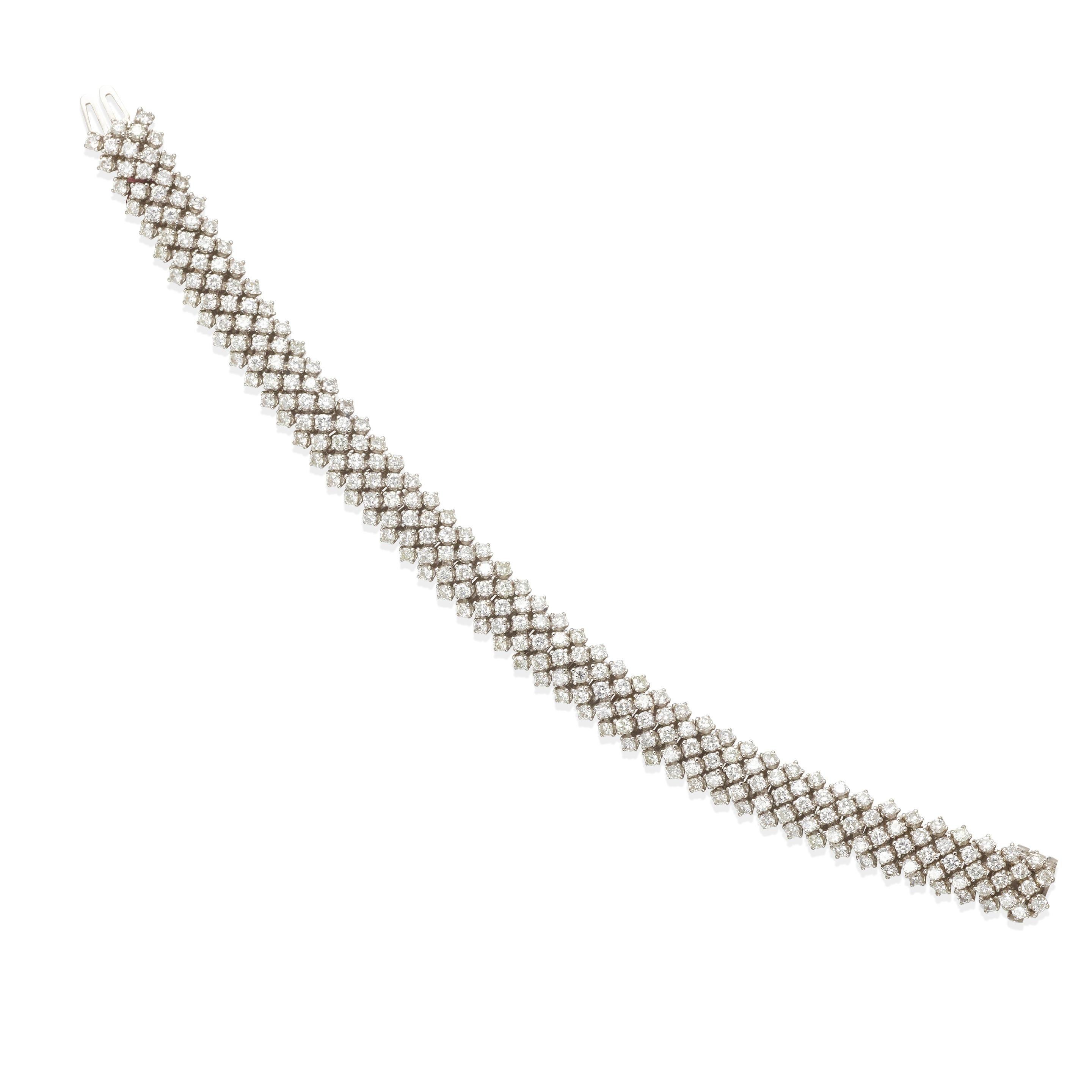This bracelet features approximately 235 round diamonds, weighing approximately 11.75 carats, set delicately in 14K white gold. 
