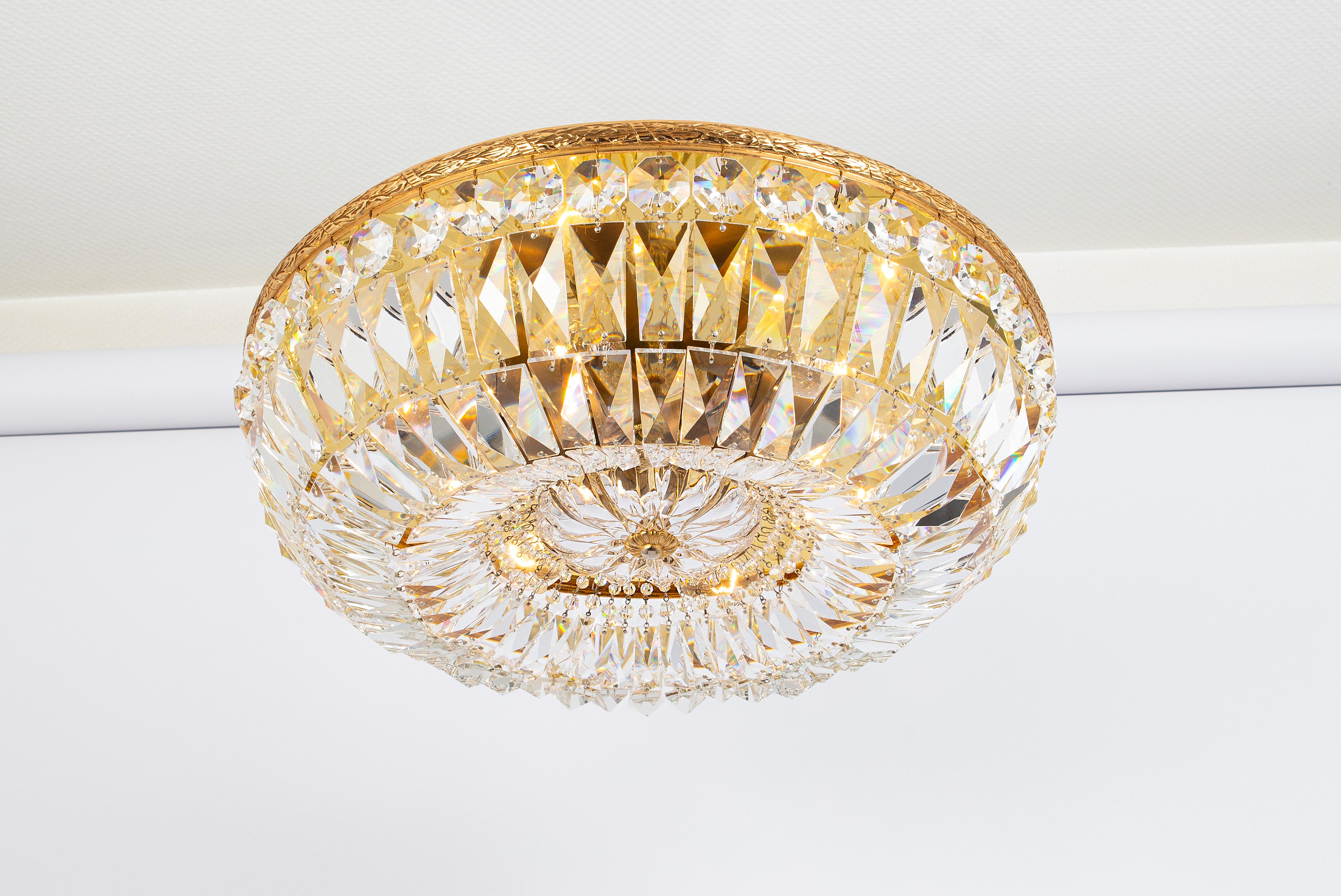 Petite Delicate floral Flush mount with crystal glass and gilded brass parts made by Palwa, Germany, 1970s. Featuring a multitude of crystal glasses.
It is an exquisite lighting fixture that combines elegance, functionality, and a touch of luxury to