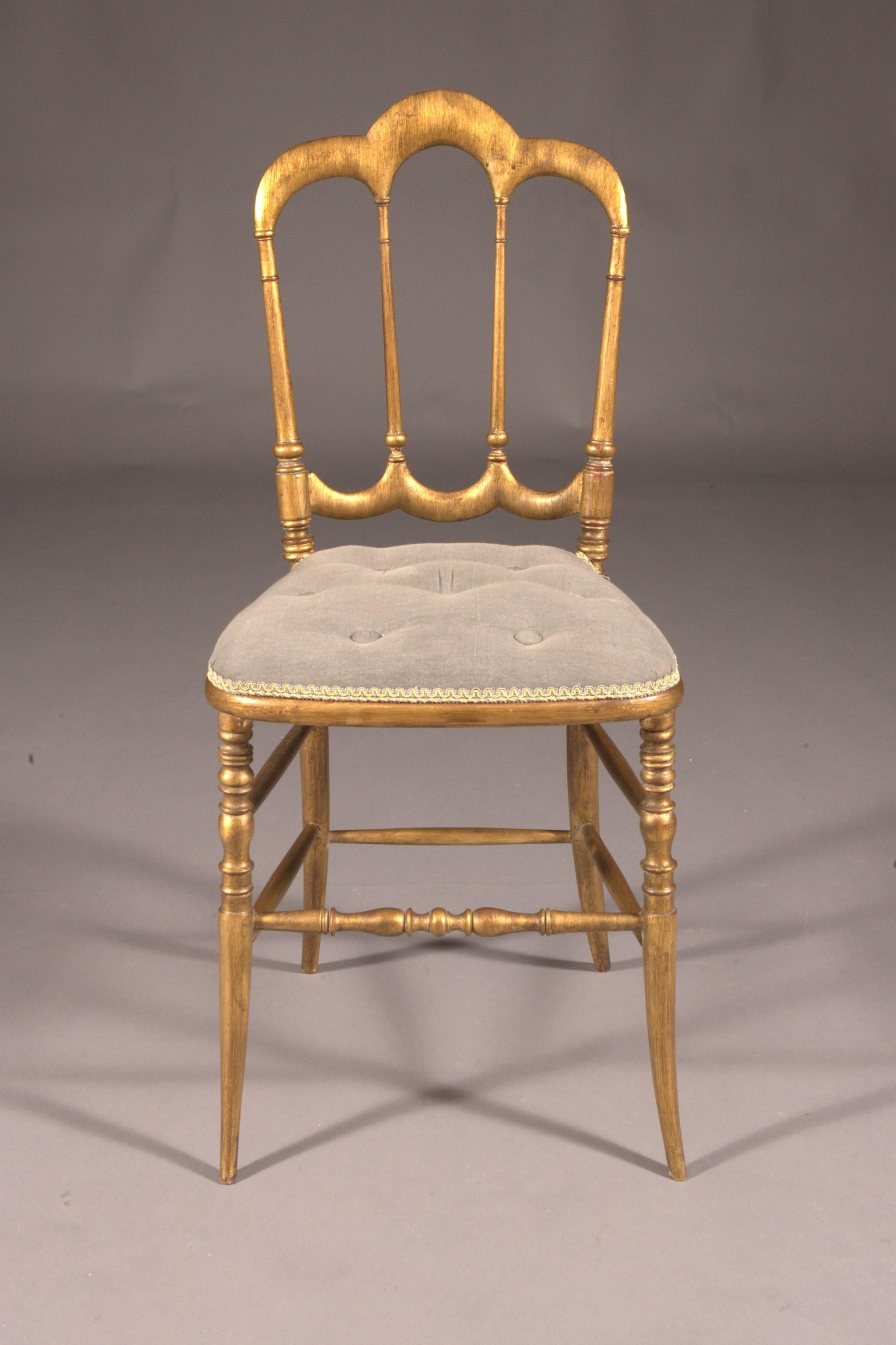 Solid beechwood, turned and grasped. Trapezoidal frame on conical balustrade-shaped legs, connected by straight struts. High backrest frame, perforated balustrade-shaped middle bars in crown form. Seat surface upholstered and covered. This chair is