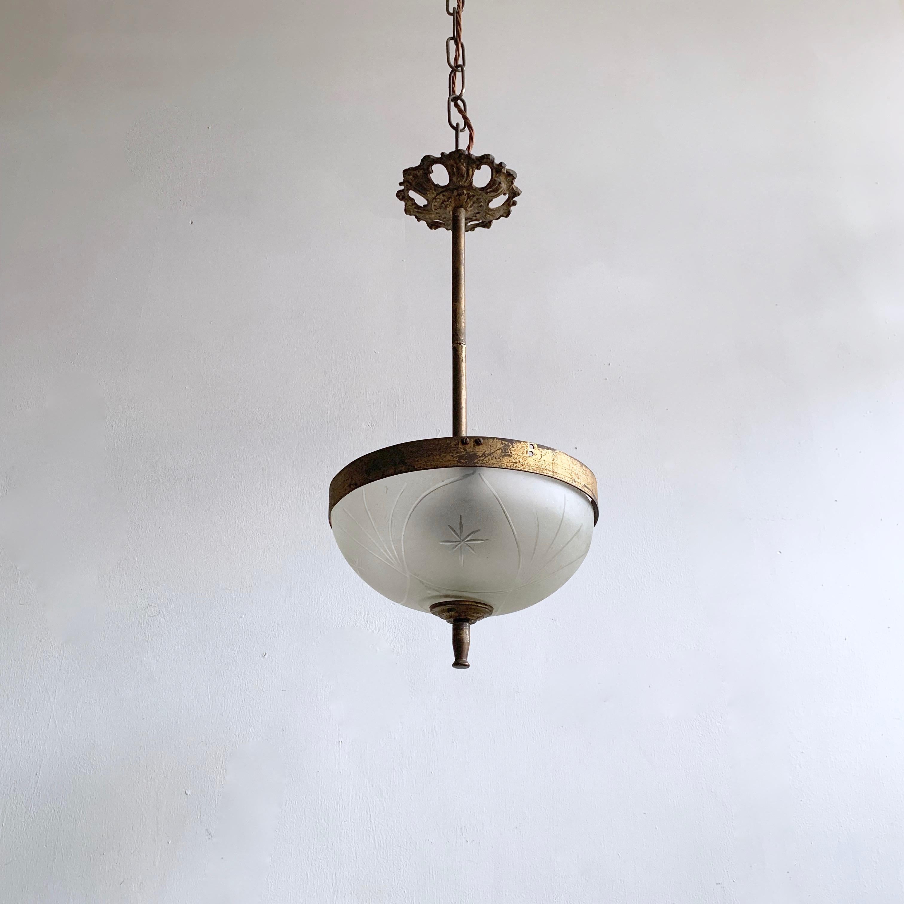 Delicate early 1900s French pendant with naturally aged brass frame and a frosted cut glass shade. Its small proportions would make it perfect for a hallway or landing space. The pendant comes supplied with braided flex, chain and a ceiling rose