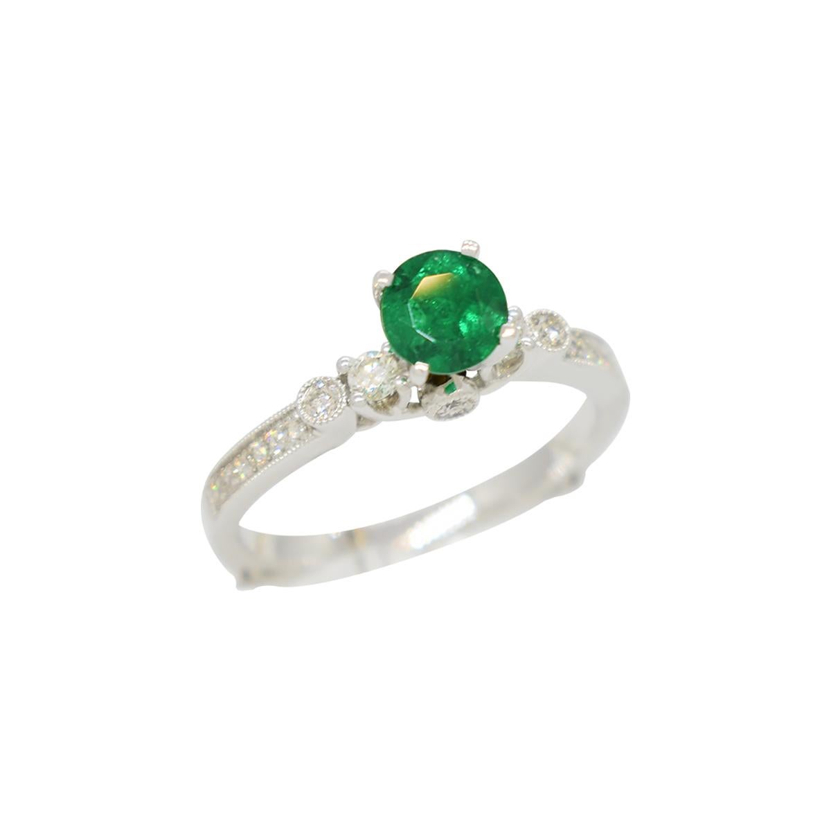 14K white gold diamond and emerald ring with 0.50 carats round cut genuine natural Colombian emerald set in prongs and 20 round cut diamonds in 0.39 carats, total weight, set in fine micro pave.  

All the fine details around the diamonds, the thin