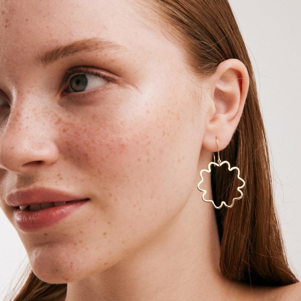 Introducing the 14K Solid Gold Flower Hook Earrings, an embodiment of Orena Jewelry's pursuit of perfection. Each earring is meticulously handcrafted, exuding an aura of refined elegance and classic sophistication. They are an exquisite choice for