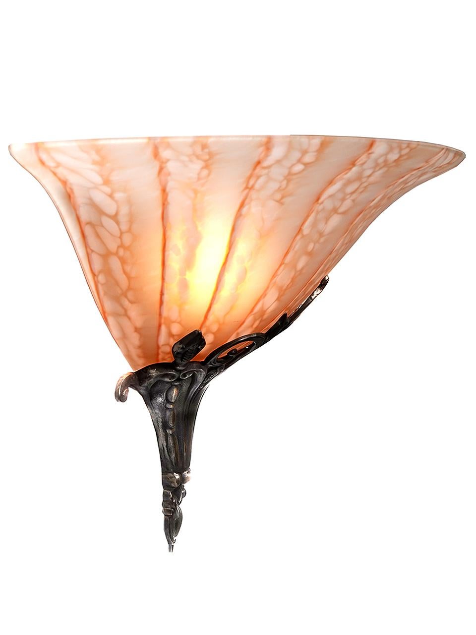 This is a beautiful and impressive sconce. The art glass shade is well over 13 inches wide. They were manufactured in Paris by ARTA. We have a small matching collection of them.