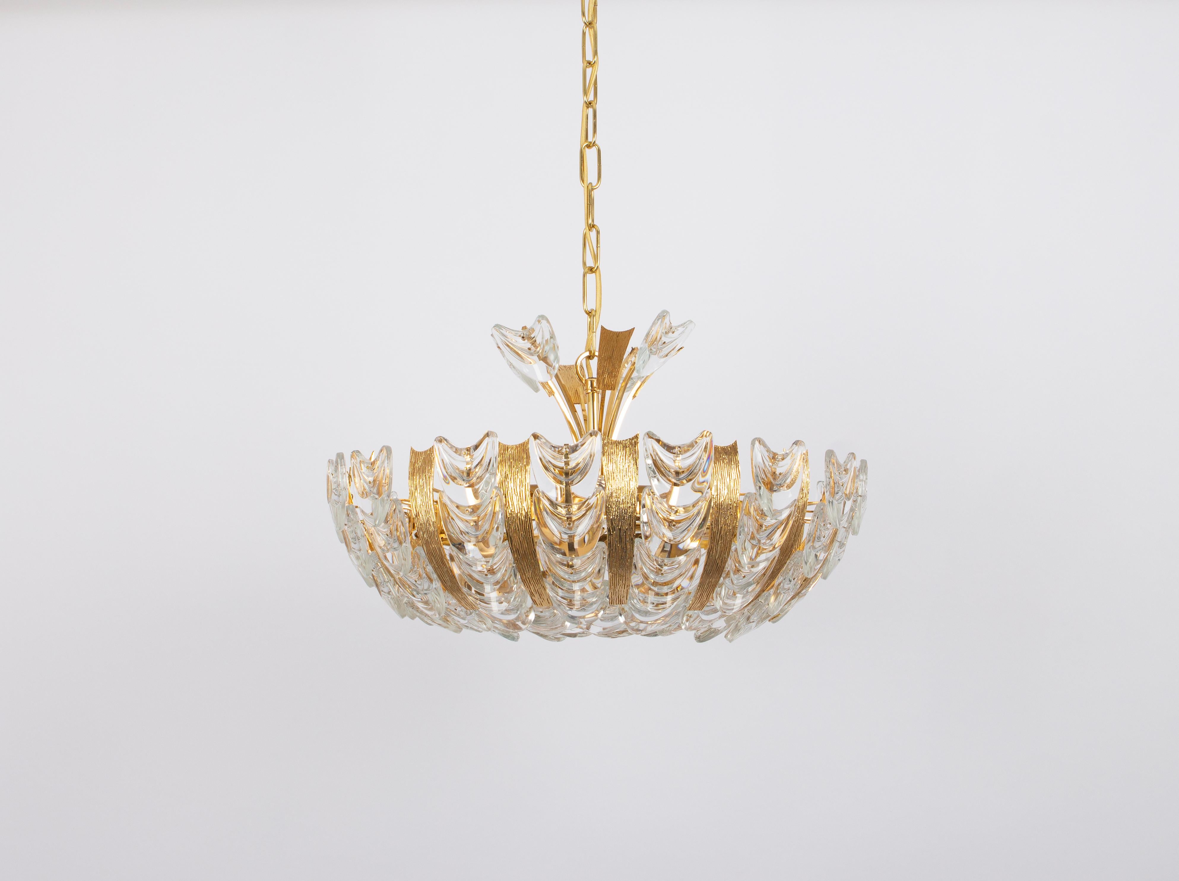 Delicate floral chandelier with crystal glass and gilded brass parts made by Palwa, Germany, 1970s. Featuring a multitude of crystal glass flowers.
Measures: Diameter 18.5
