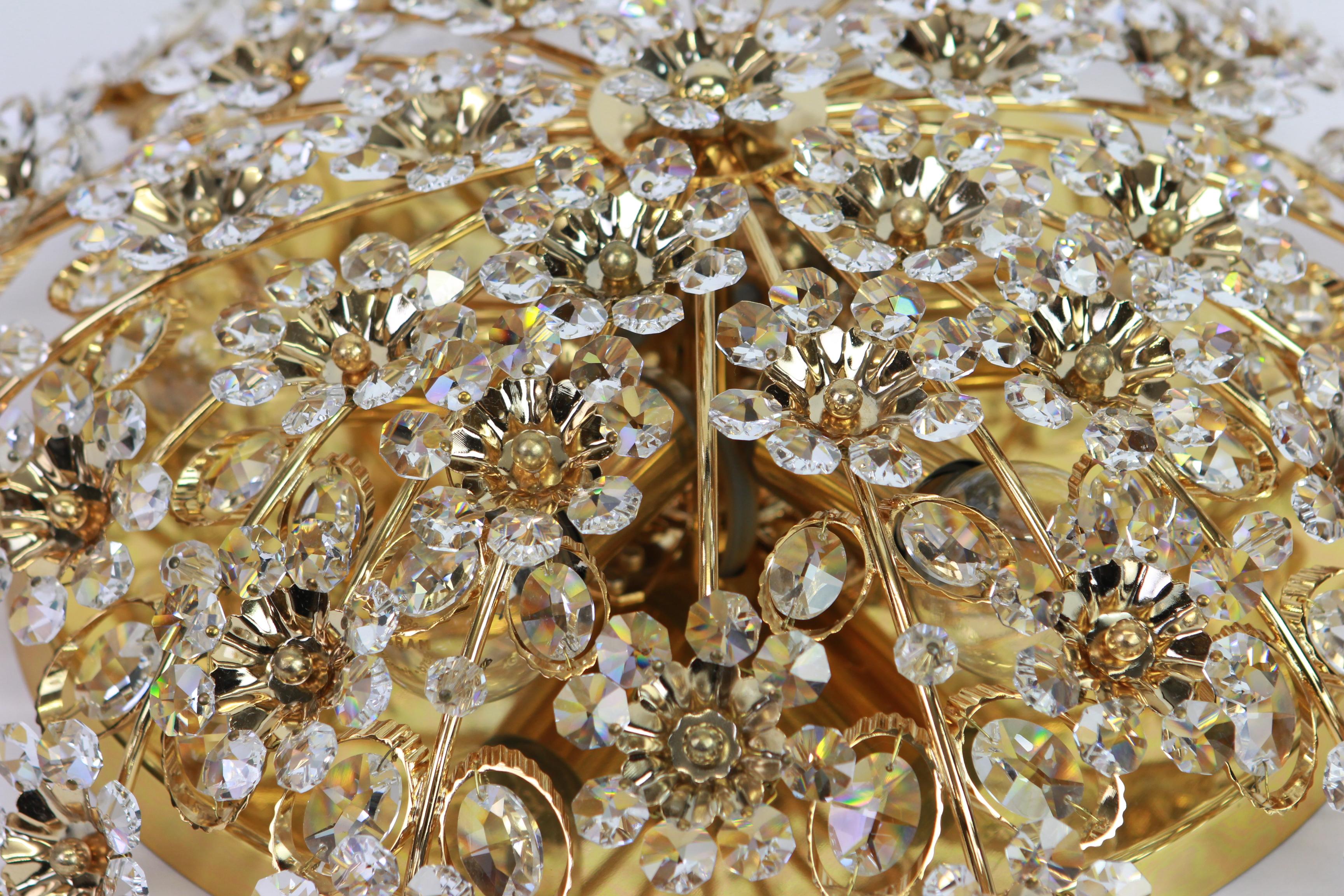Delicate floral chandelier with crystal glass and gilded brass parts made by Palwa, Germany, 1970s. Featuring a multitude of crystal glass flowers.

Sockets: Six small bulbs with each 40W (Compatible with the US / UK / .. standards).
Very good