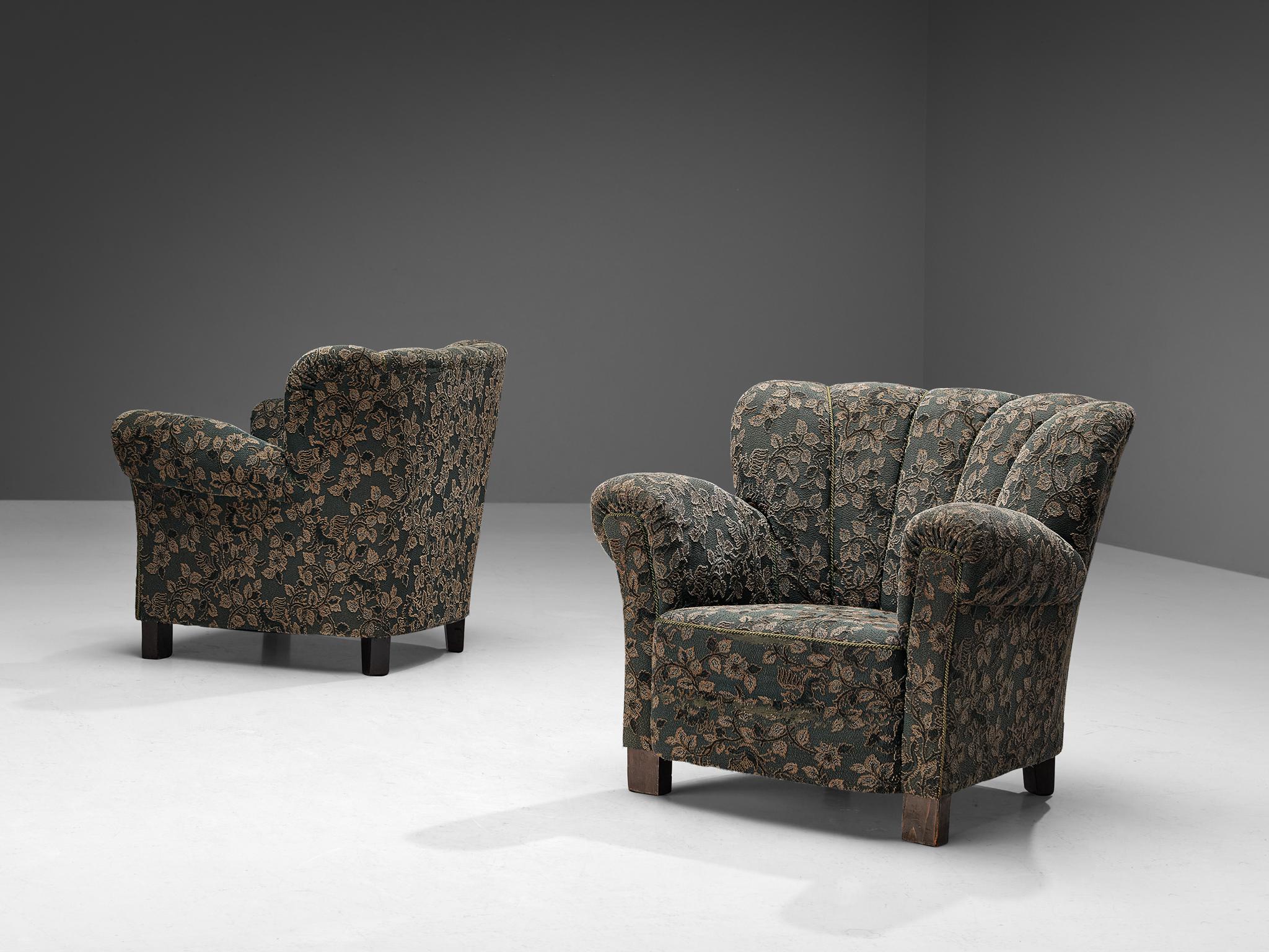 Pair of club chairs, fabric, stained beech, Czech Republic, 1950s.

These chairs are beautifully constructed featuring a shell shaped frame composed of diverging lines that brings a more open and inviting look to the quite solid design. The
