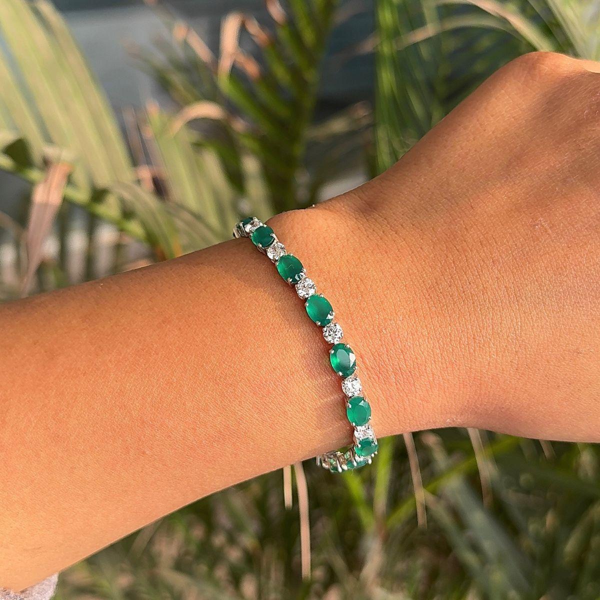 Delicate Prong Set Emerald Birthstone Tennis Bracelet in sterling silver showcases endlessly sparkling natural emerald, weighing 15.2 carat. It measures 7.5 inches long in length. 
Emerald stimulate concentration and reduces stress. 
Designed with